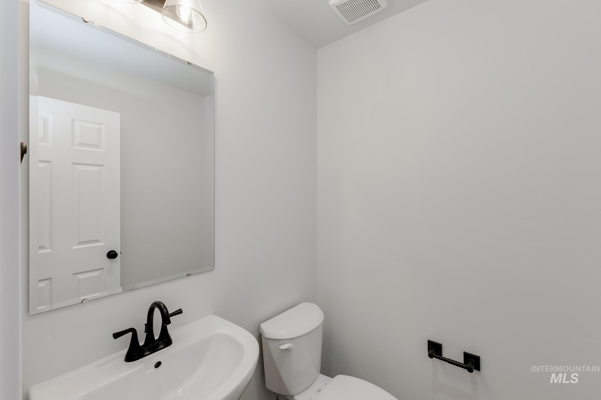 Half bath featuring a sink and toilet