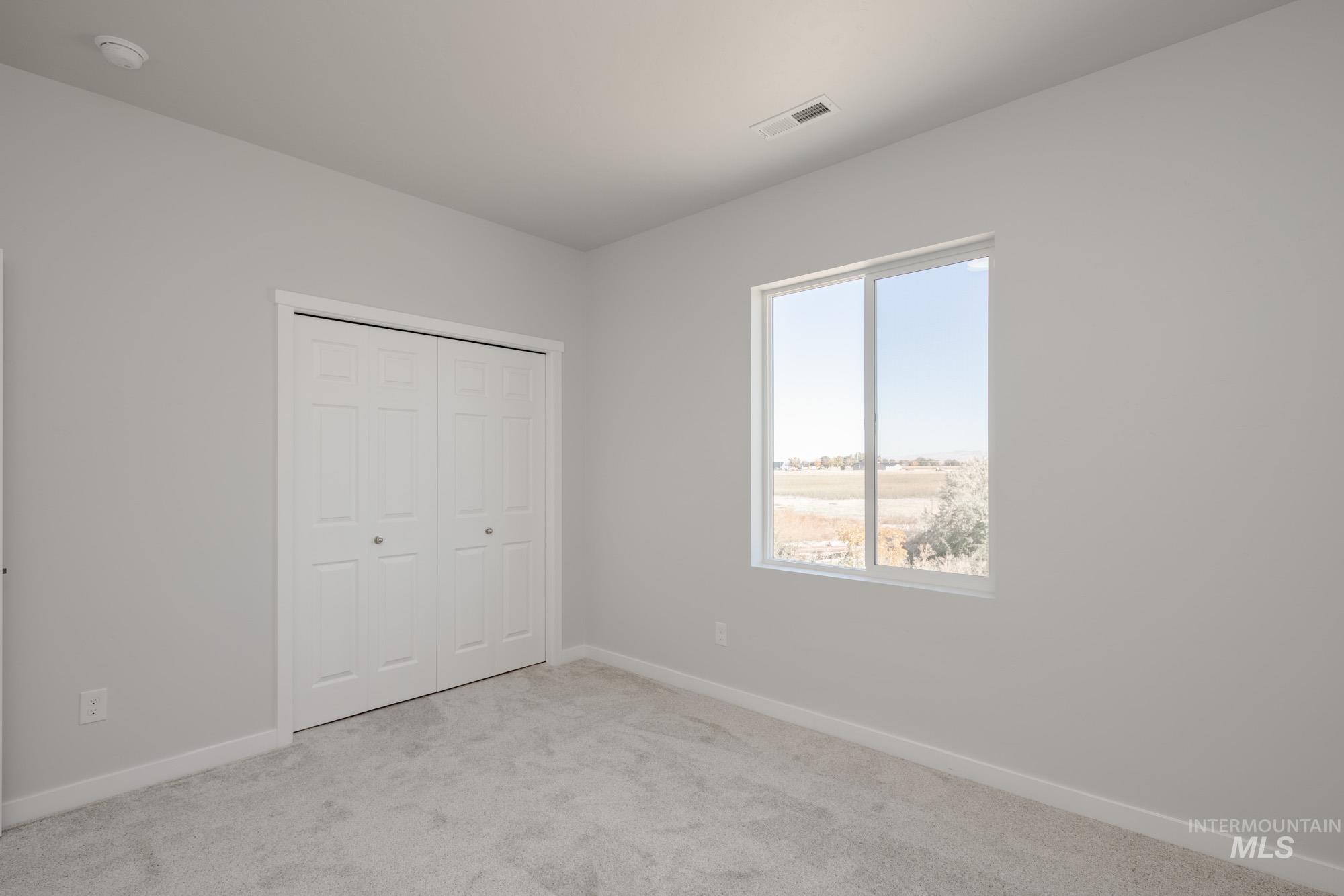 Unfurnished bedroom featuring carpet flooring and a closet