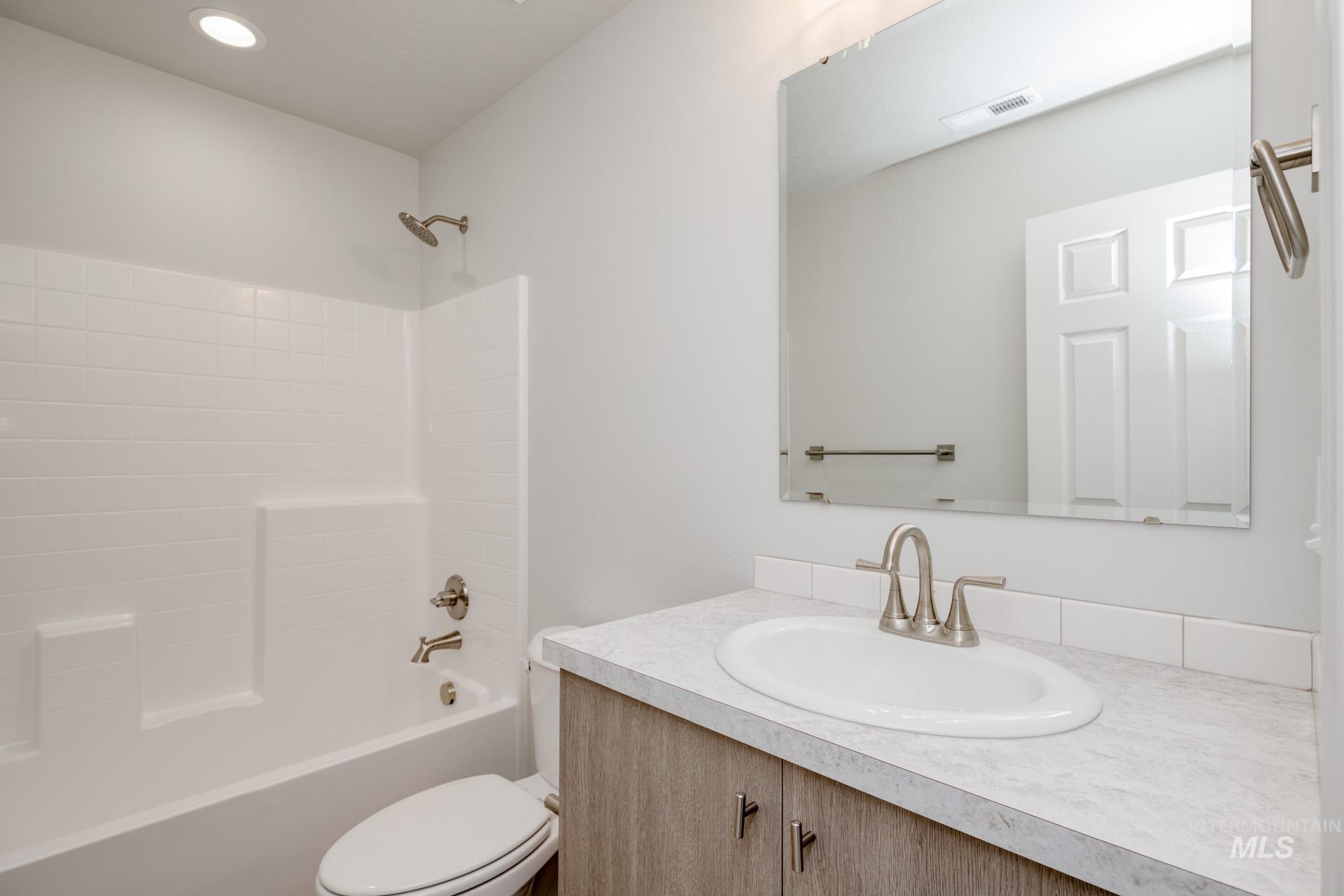Full bath featuring shower / tub combination and vanity