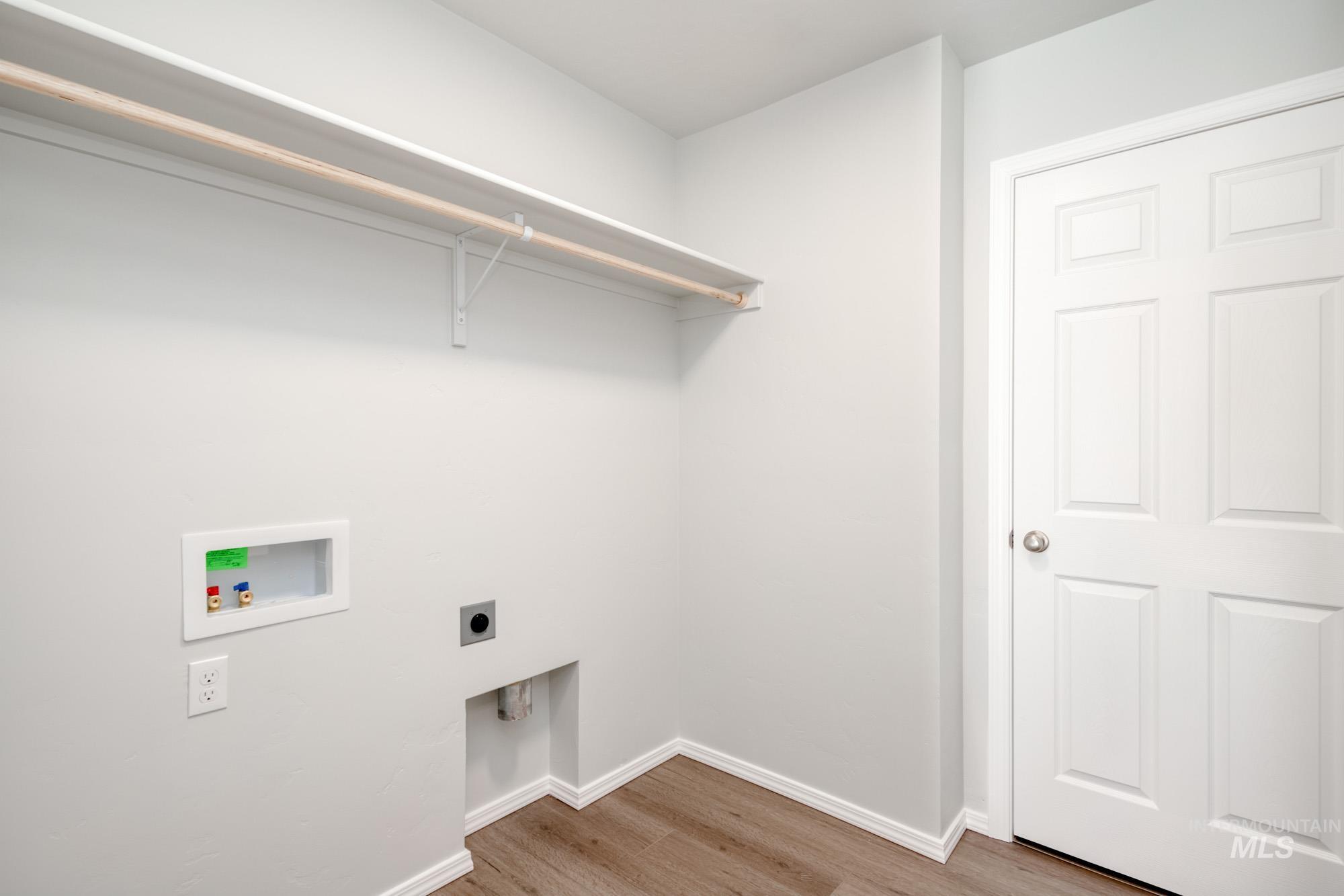 Laundry room featuring light wood-style flooring, electric dryer hookup, and washer hookup