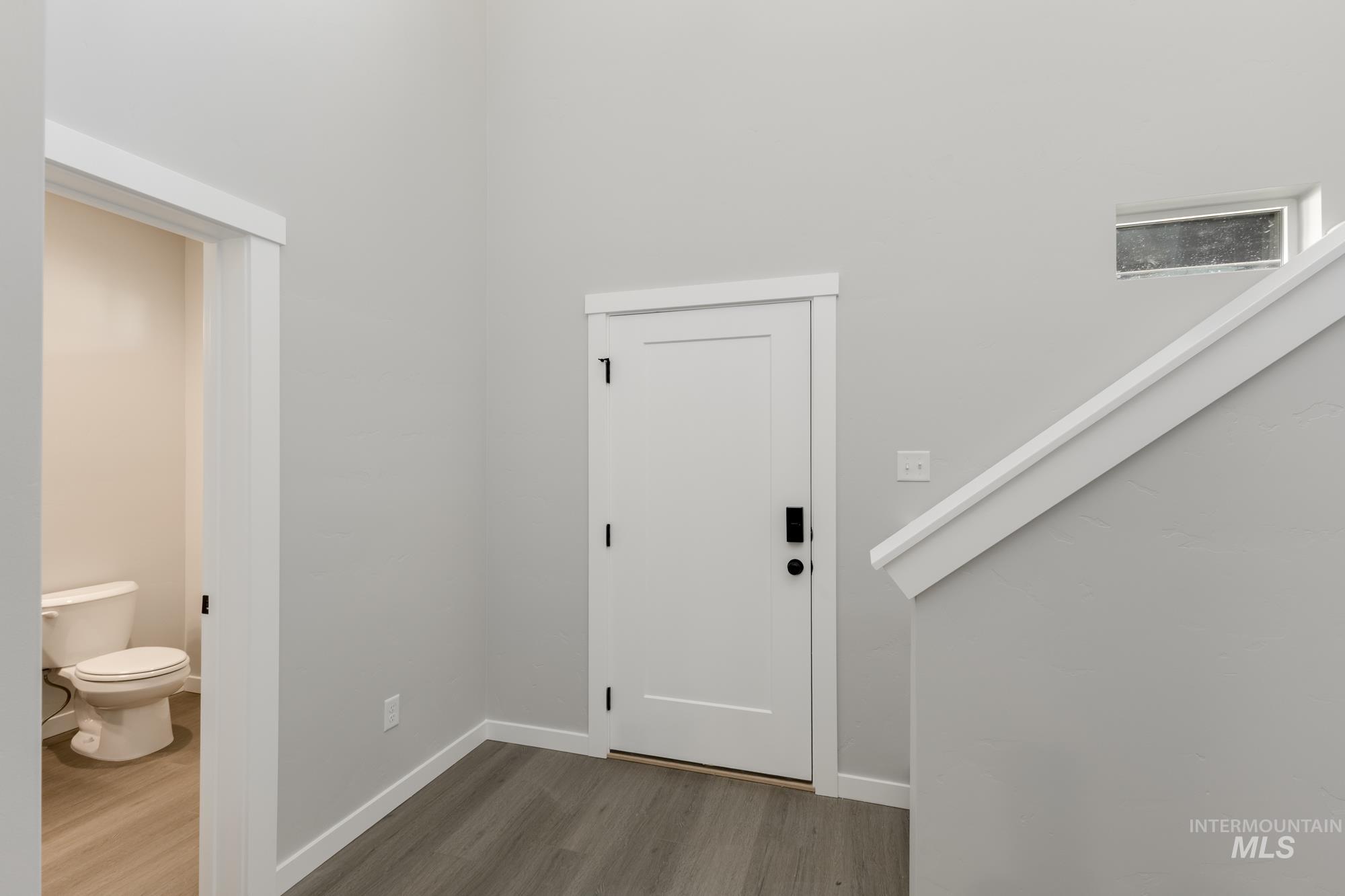 Foyer featuring stairway and dark wood-style floors