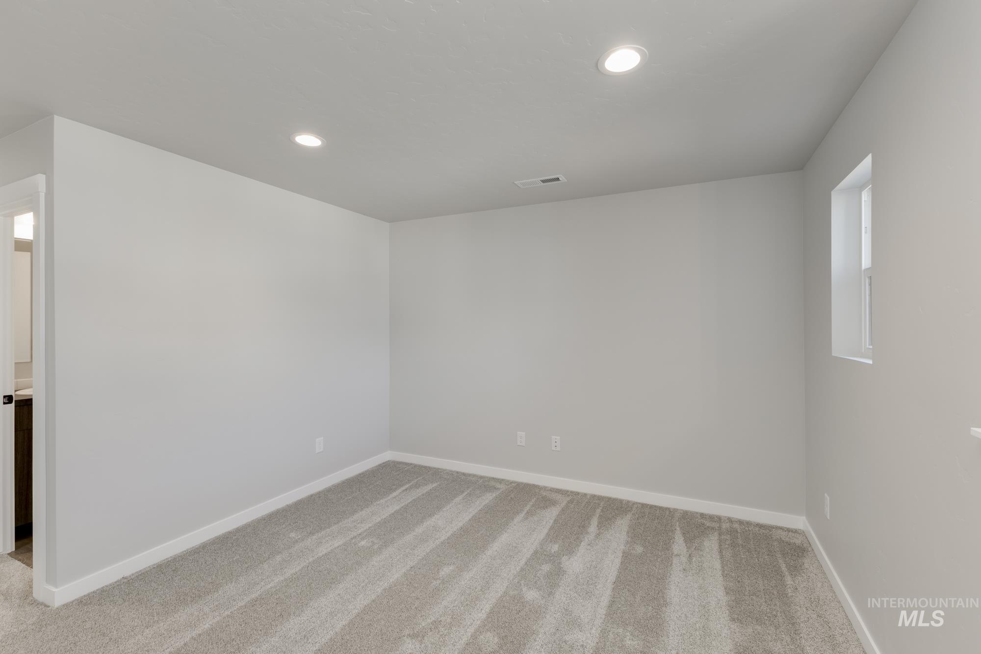 Unfurnished room featuring recessed lighting and light carpet