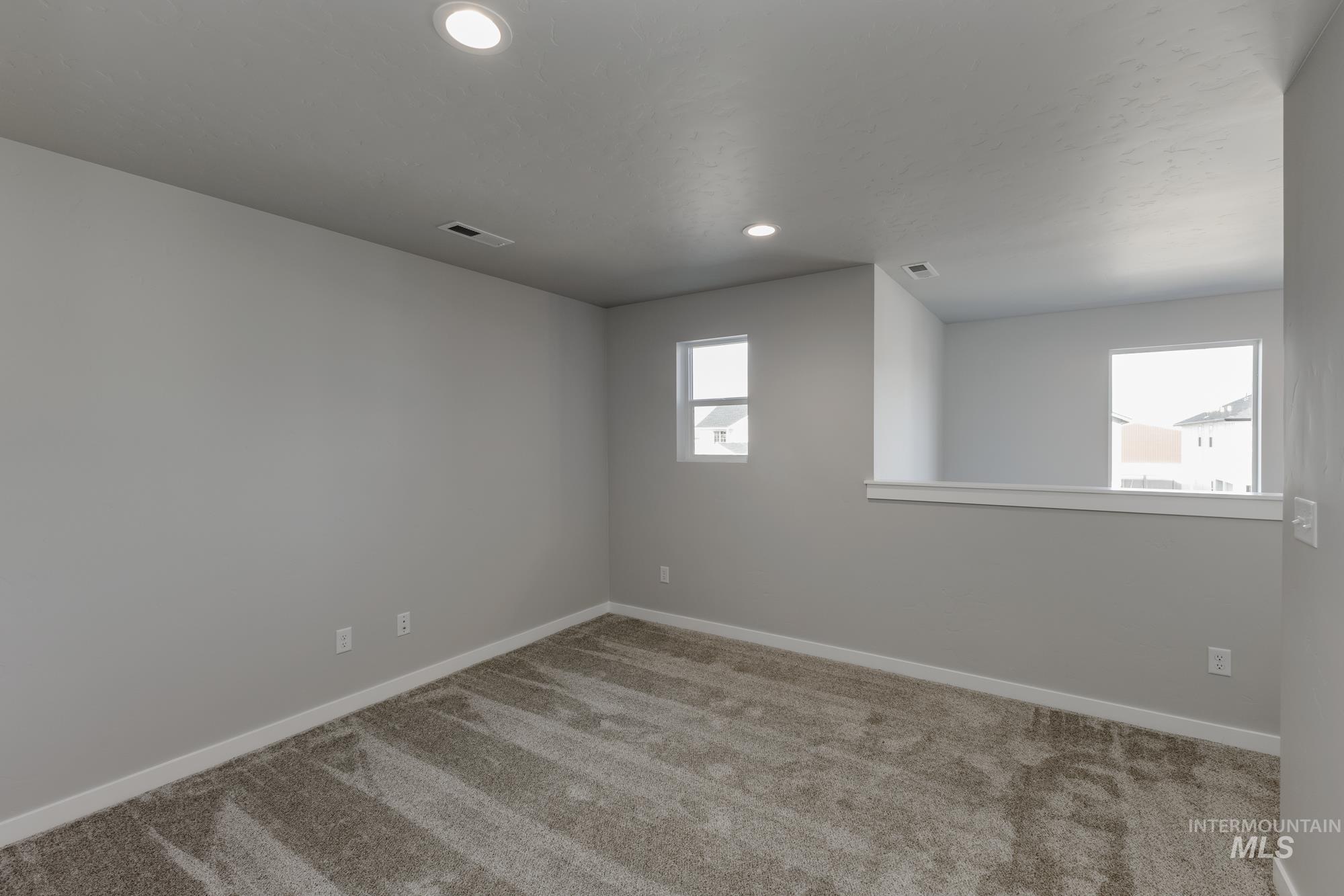 Spare room with carpet flooring and recessed lighting