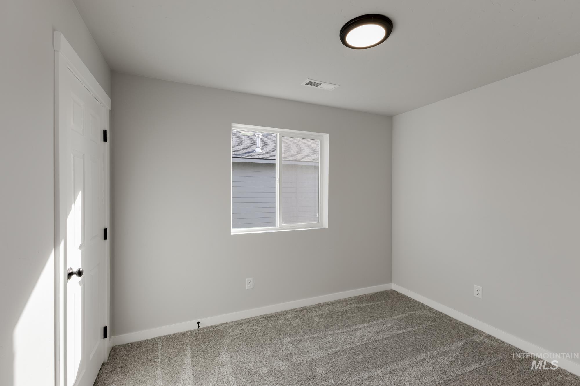 Unfurnished room with baseboards and carpet