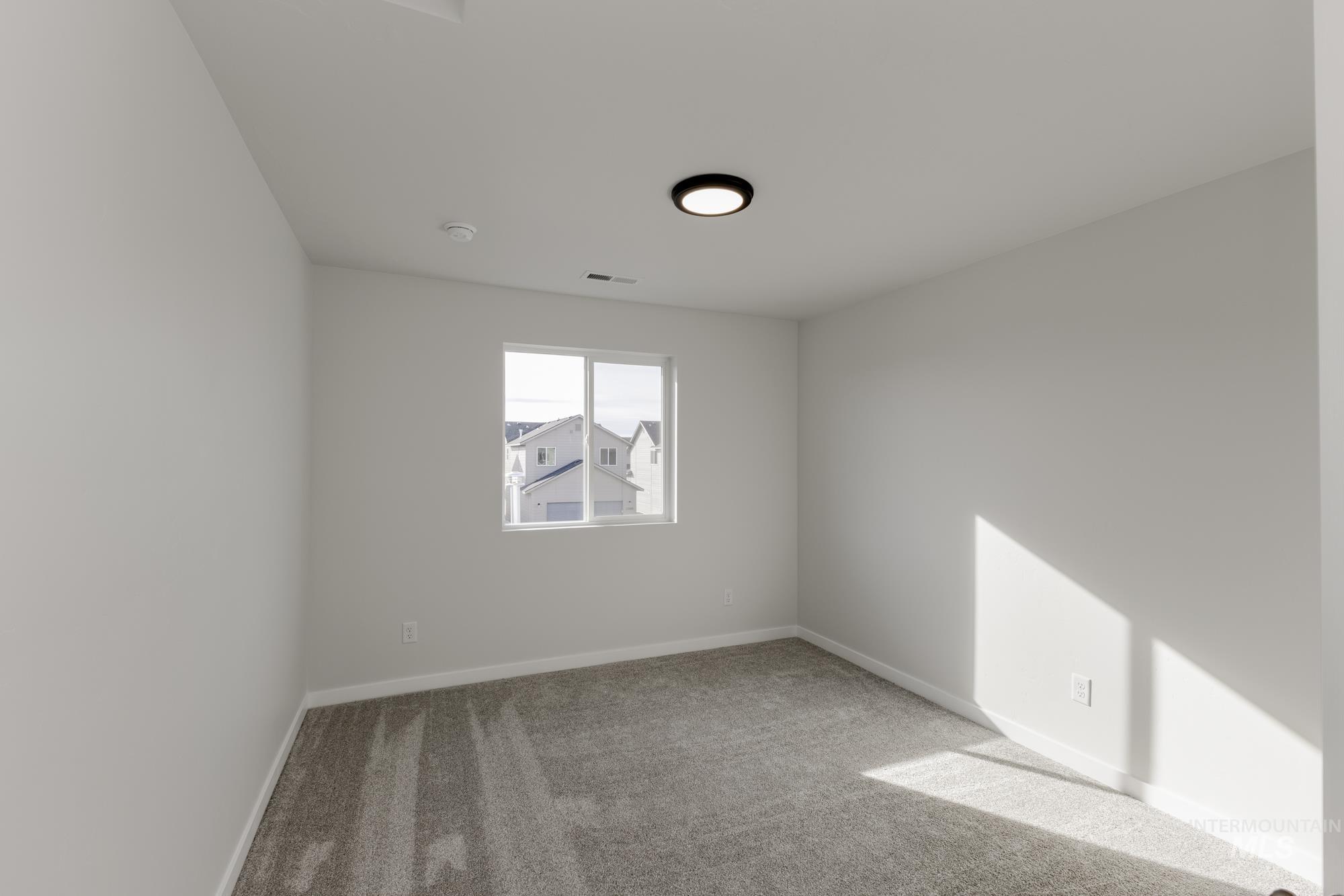 Unfurnished room featuring carpet and baseboards