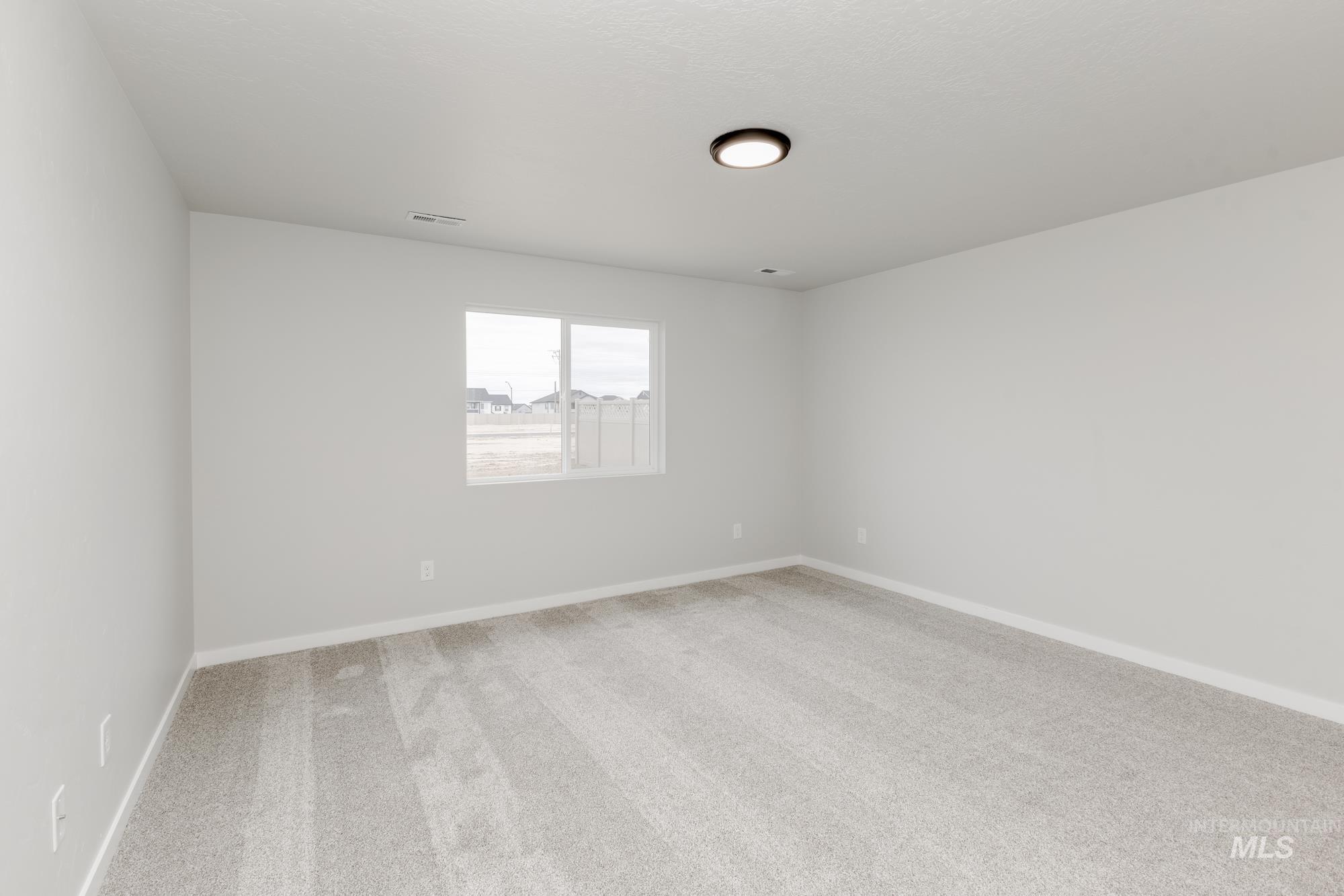 Spare room with carpet floors and baseboards