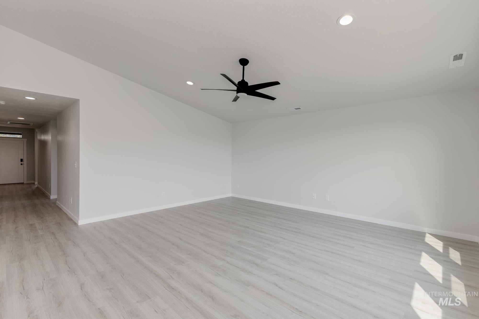 Spare room featuring light wood-style flooring, recessed lighting, and a ceiling fan