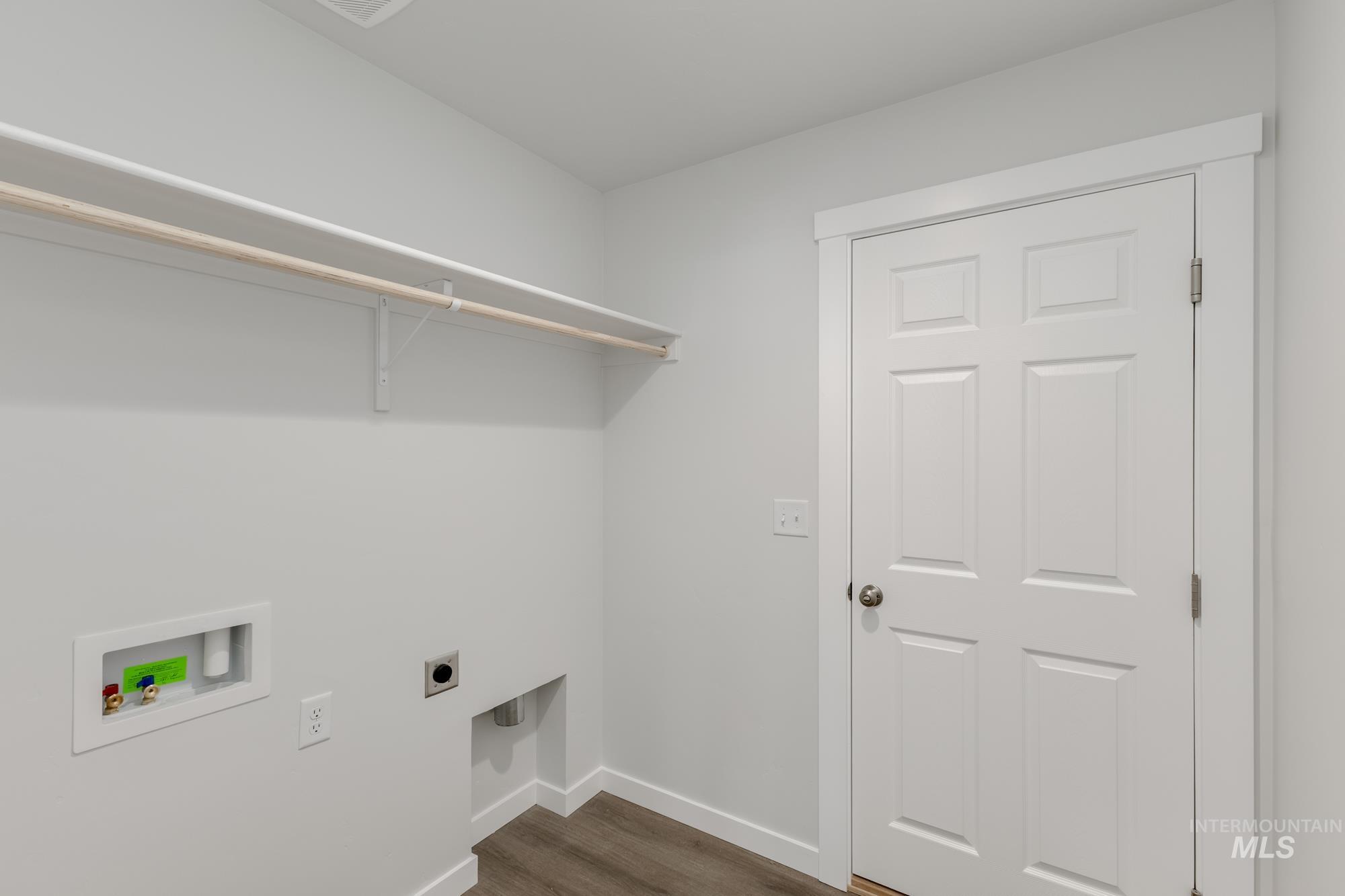 Laundry room featuring hookup for a washing machine, hookup for an electric dryer, and dark wood-type flooring