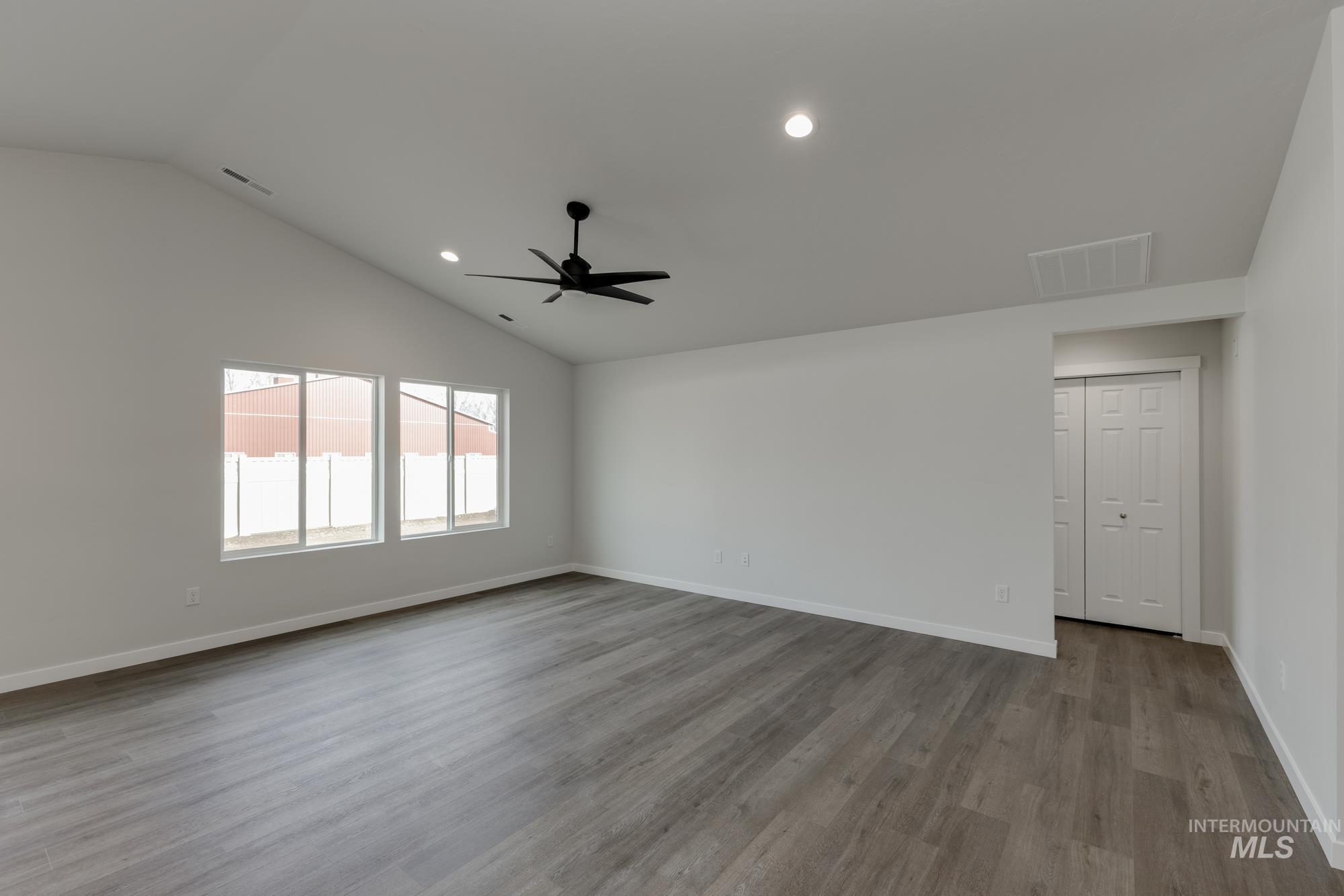Spare room featuring lofted ceiling, light wood finished floors, recessed lighting, and a ceiling fan