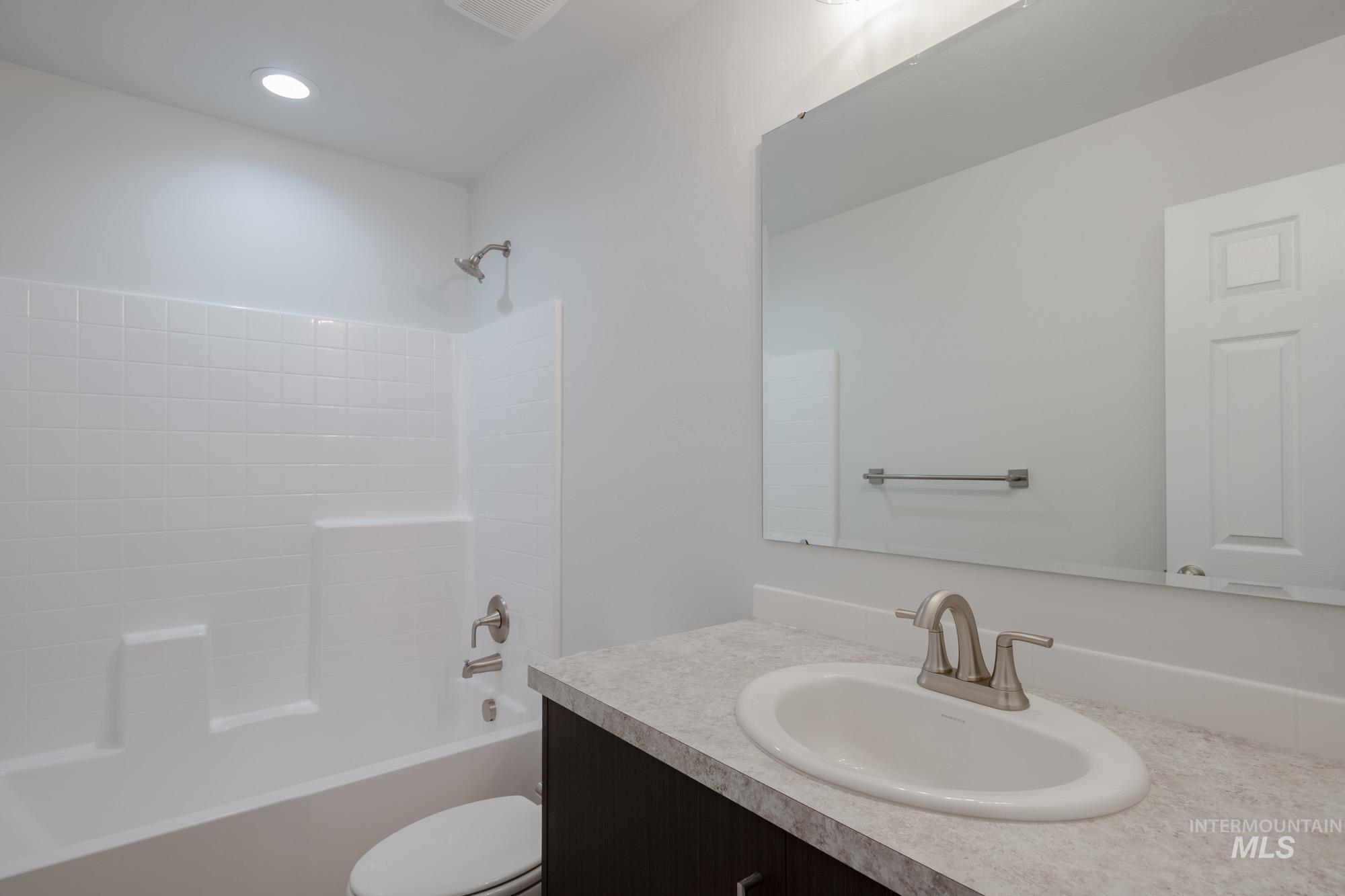 Bathroom with shower / bath combination and vanity