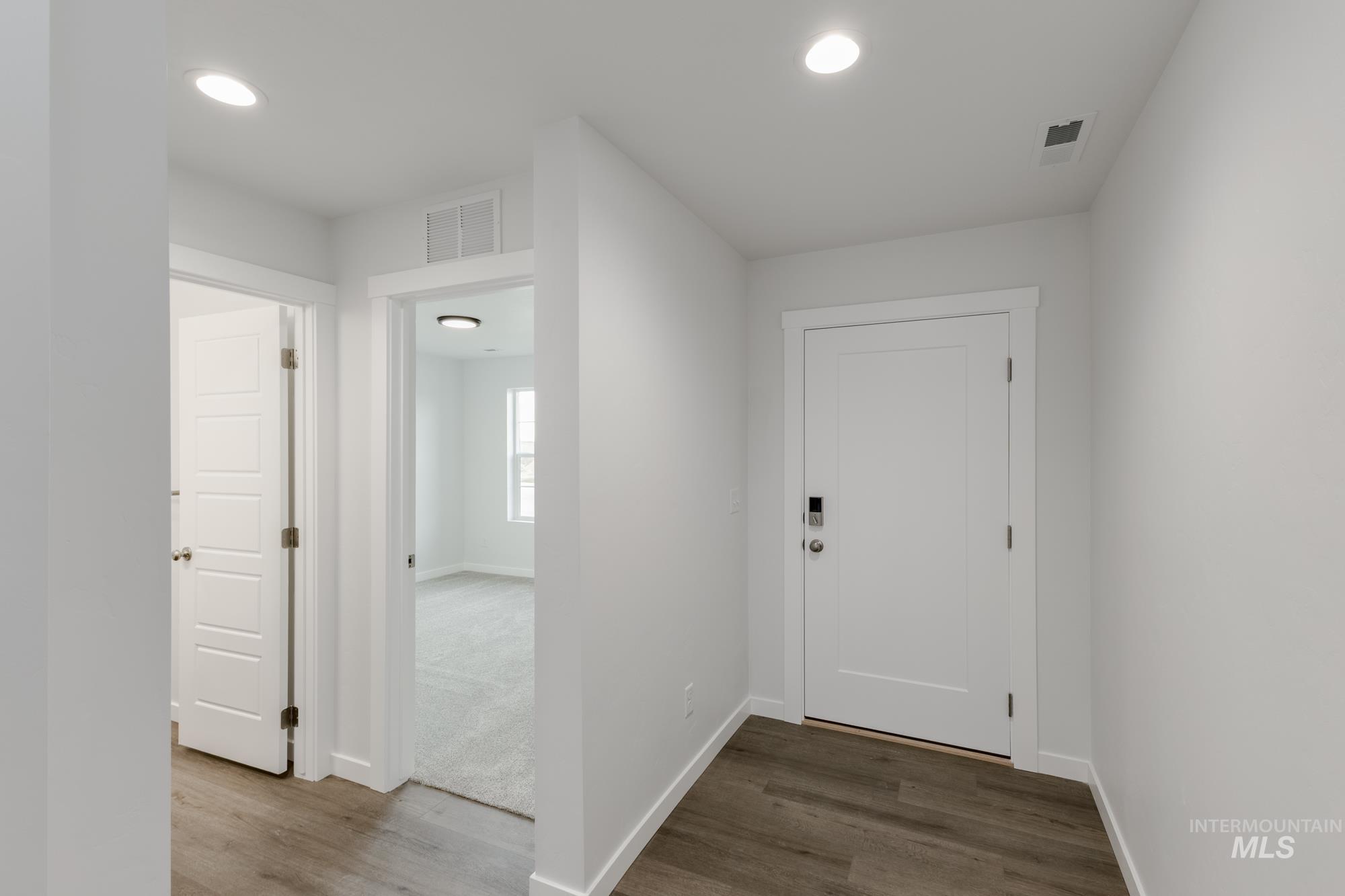 Foyer featuring dark wood-style flooring and recessed lighting