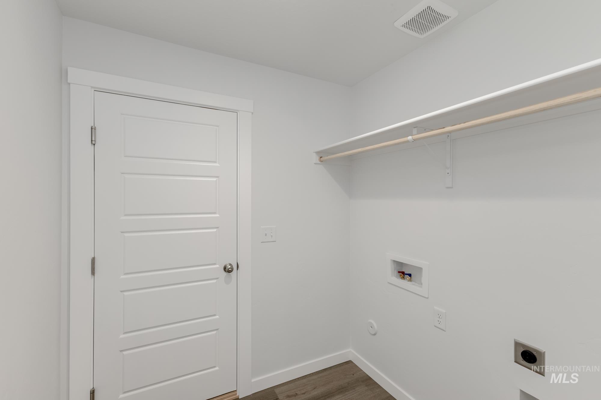 Laundry area featuring hookup for an electric dryer, washer hookup, and dark wood finished floors