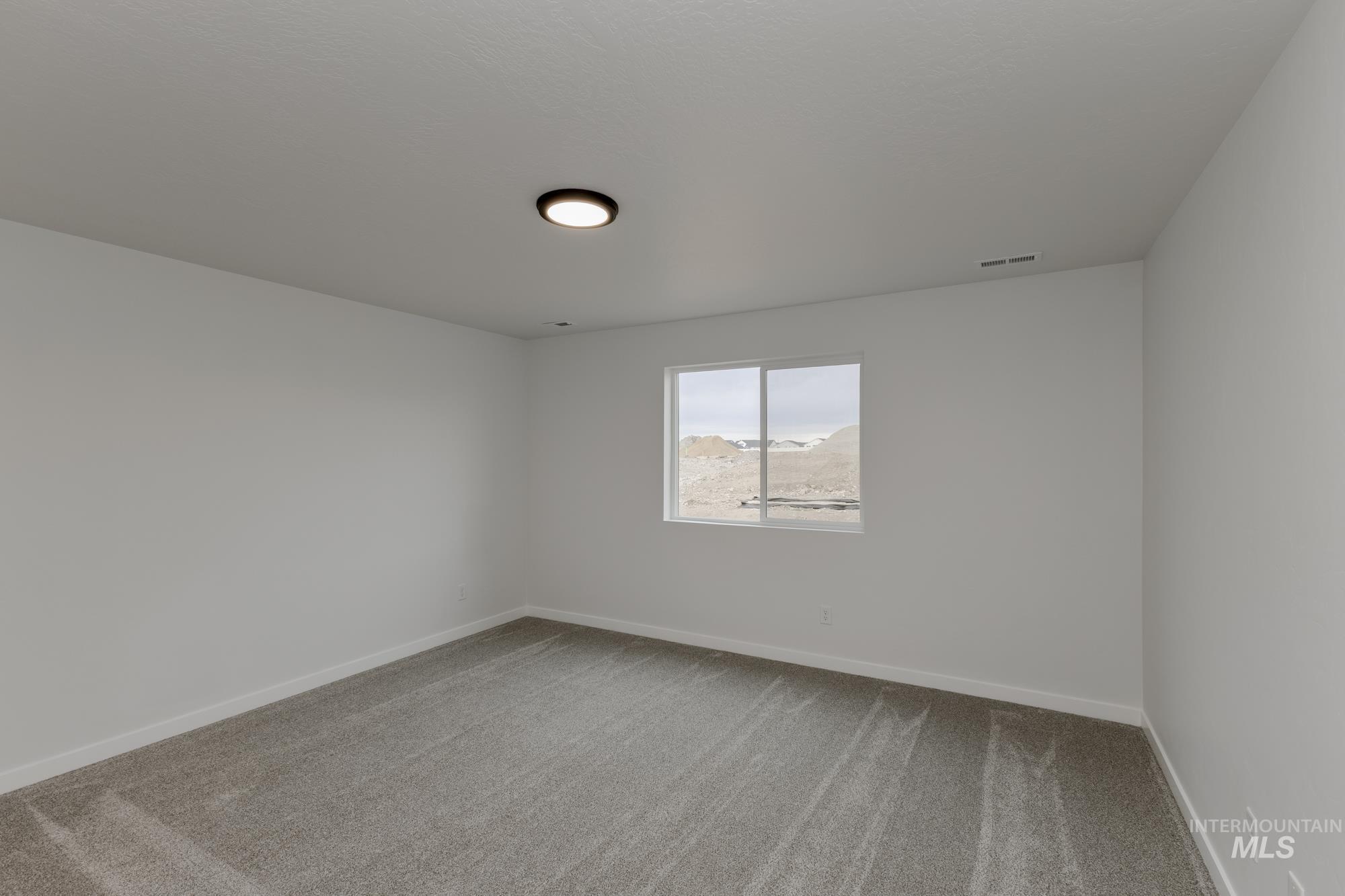 Unfurnished room with light carpet and baseboards
