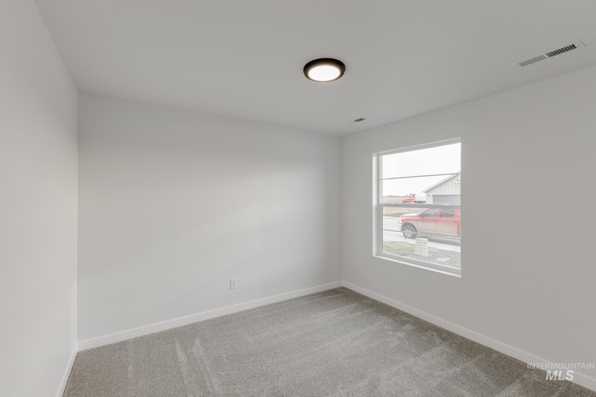 Unfurnished room featuring baseboards and light colored carpet