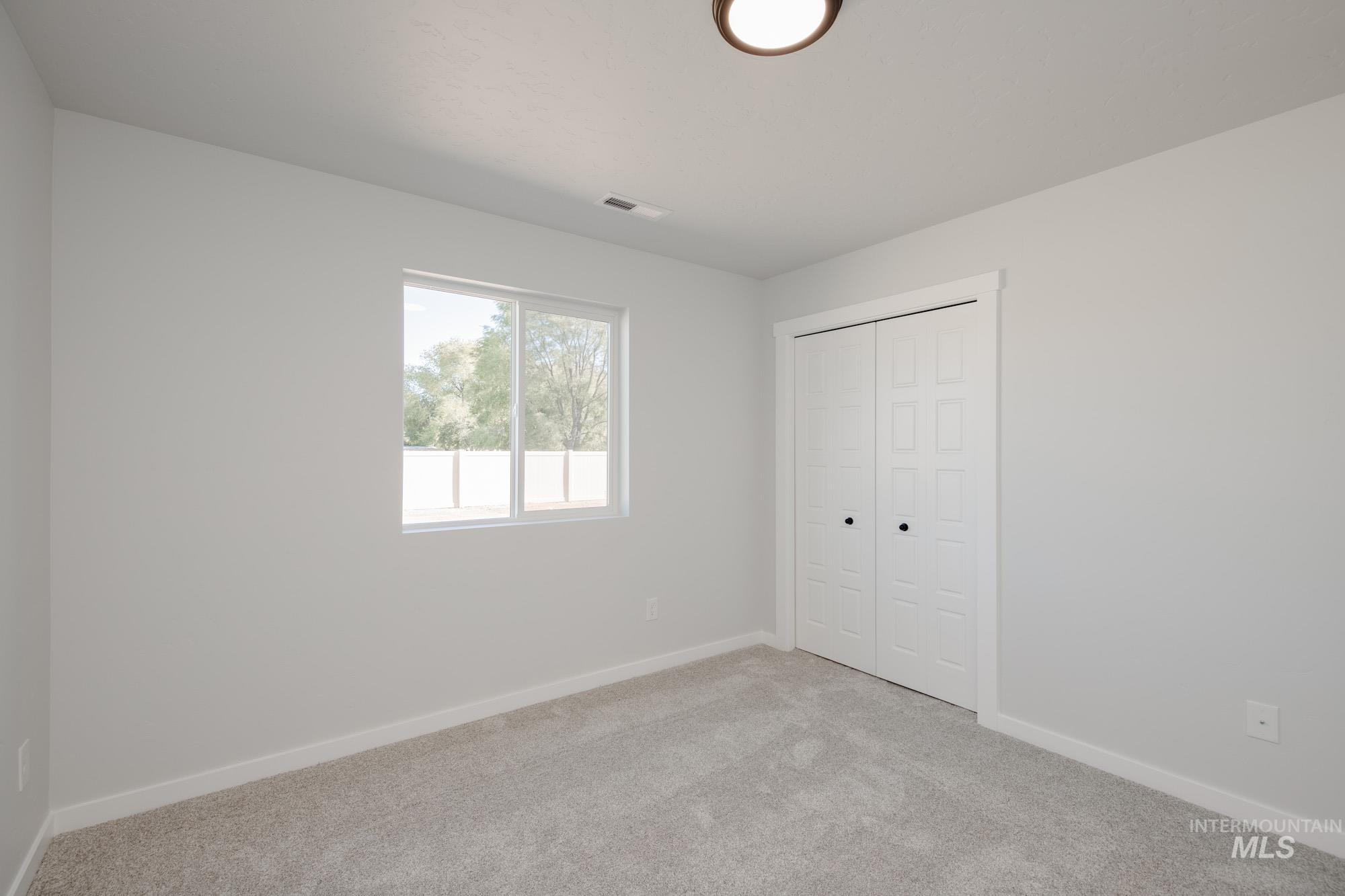 Unfurnished bedroom with carpet and a closet