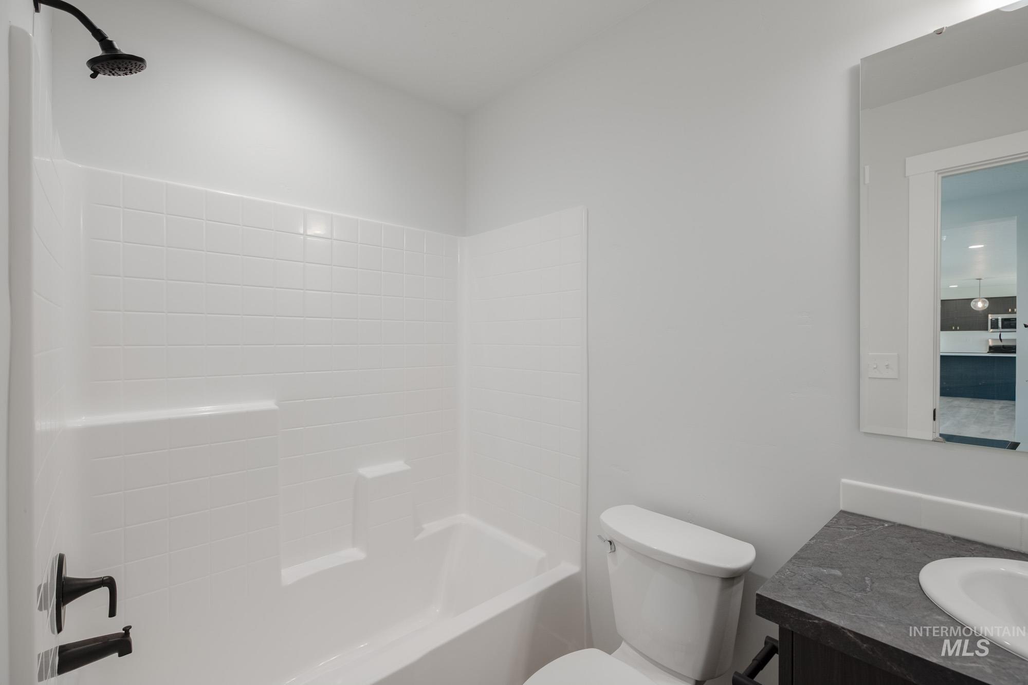 Full bath featuring vanity and bathtub / shower combination