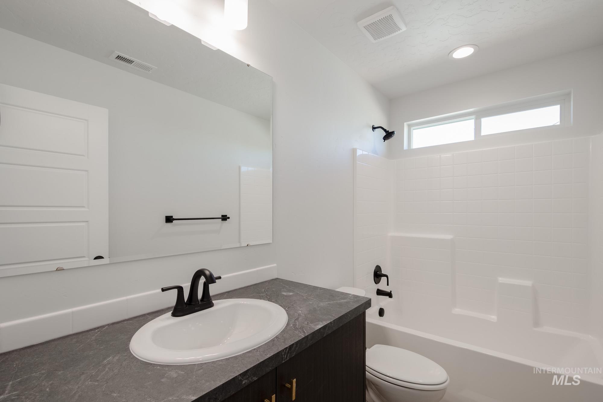 Bathroom with vanity and bathing tub / shower combination