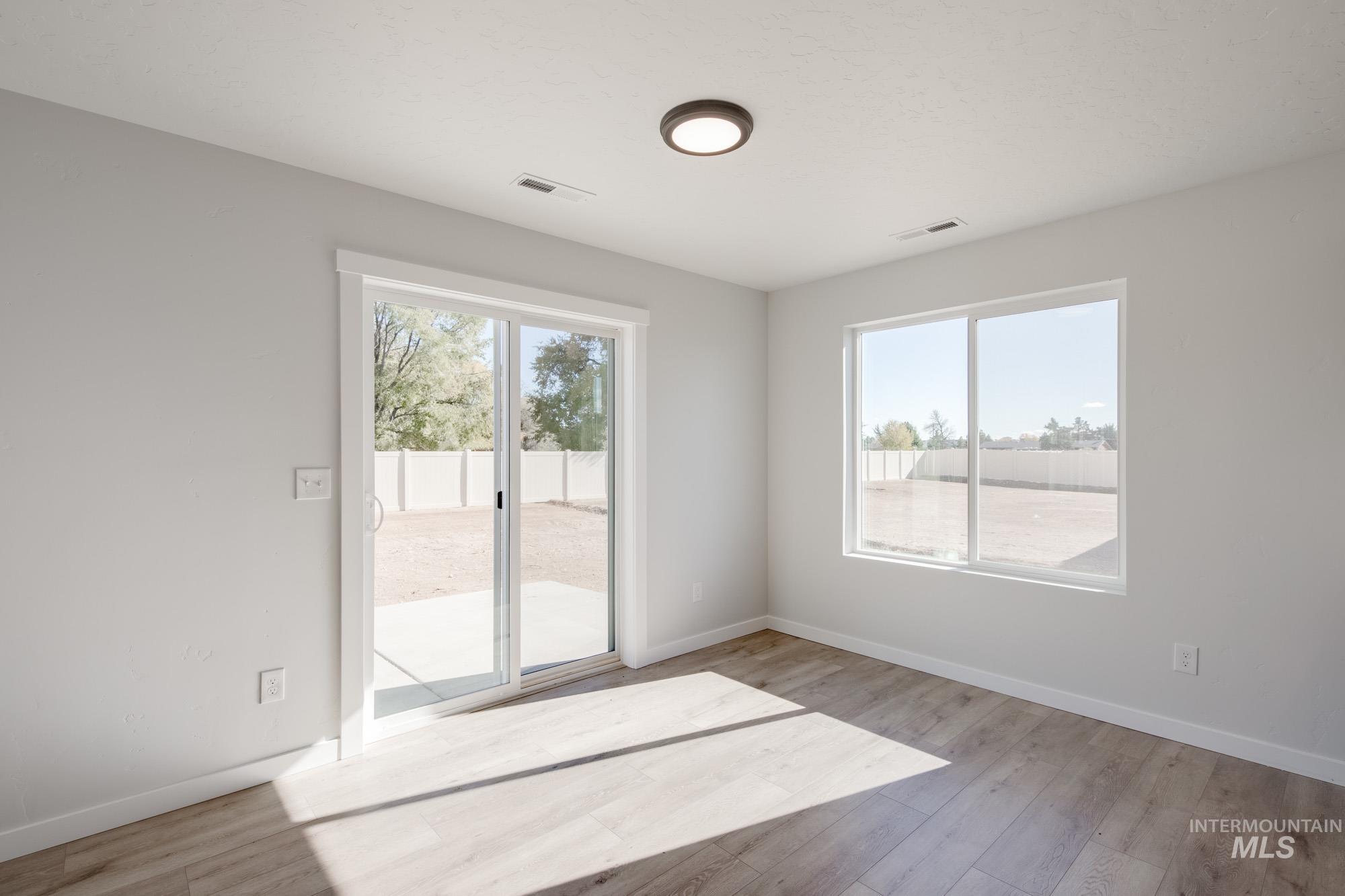 Unfurnished room with healthy amount of natural light and light wood-type flooring