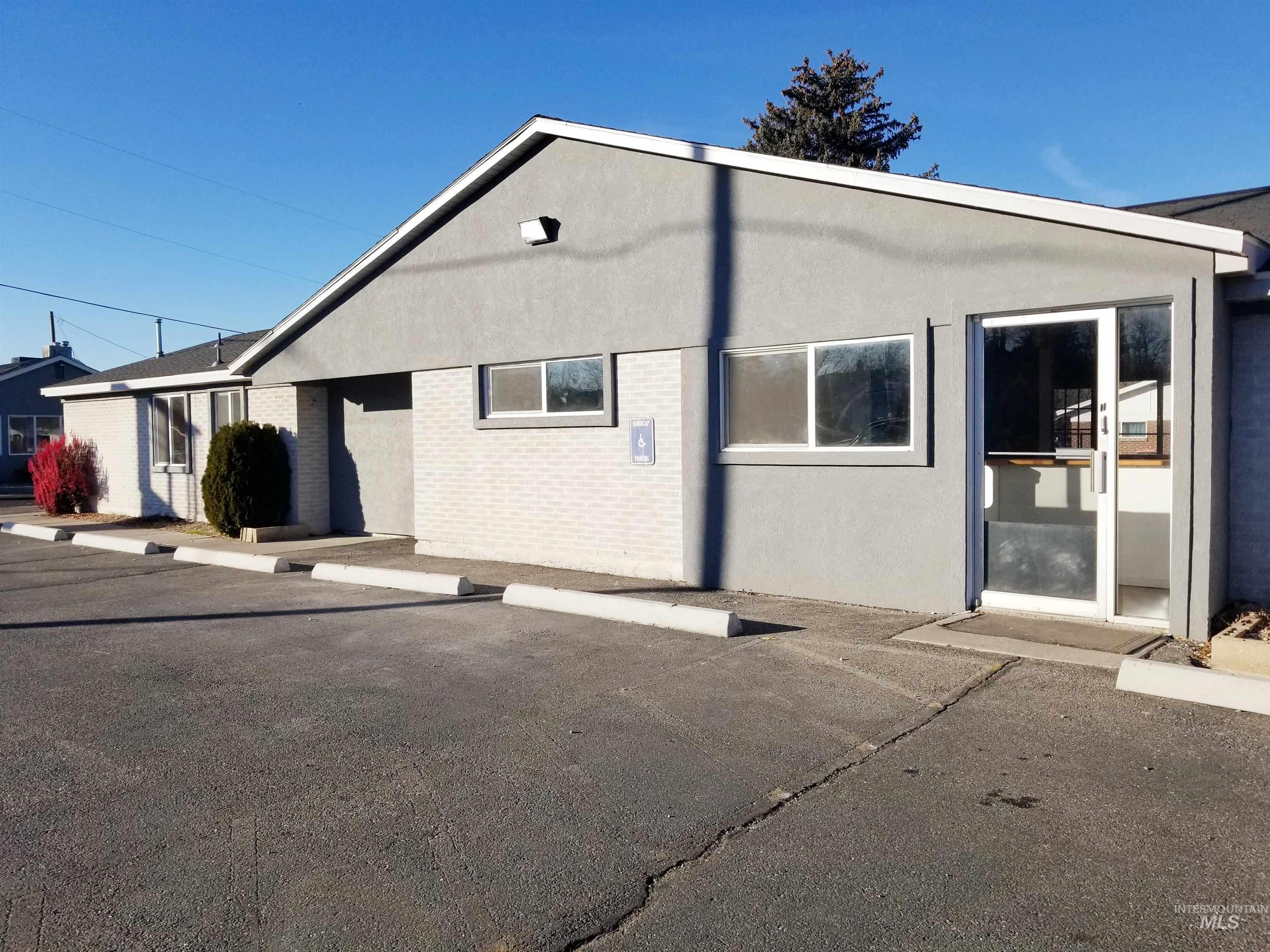Rear view of property featuring stucco siding and brick siding
