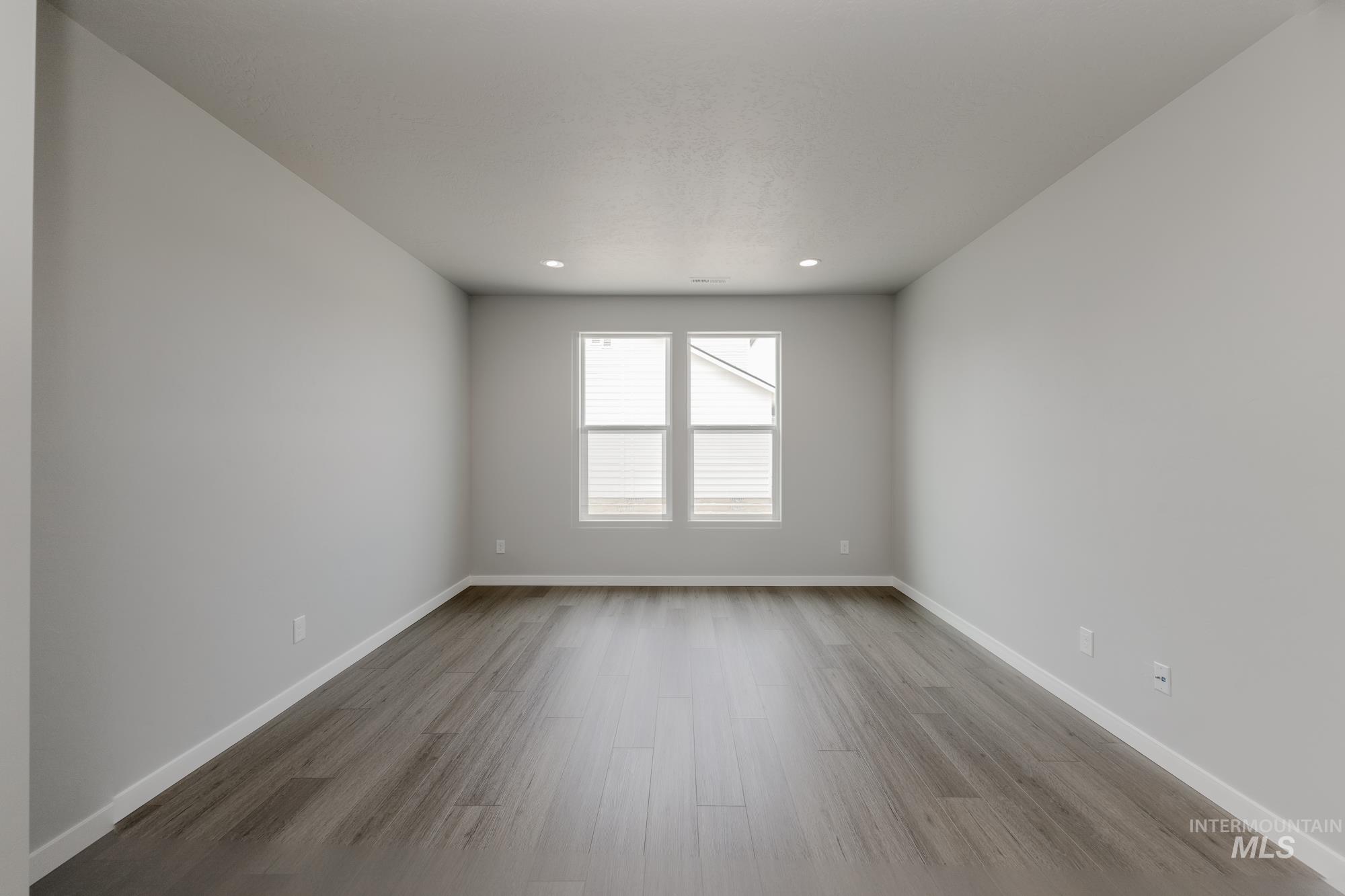 Unfurnished room with light wood-style flooring and recessed lighting
