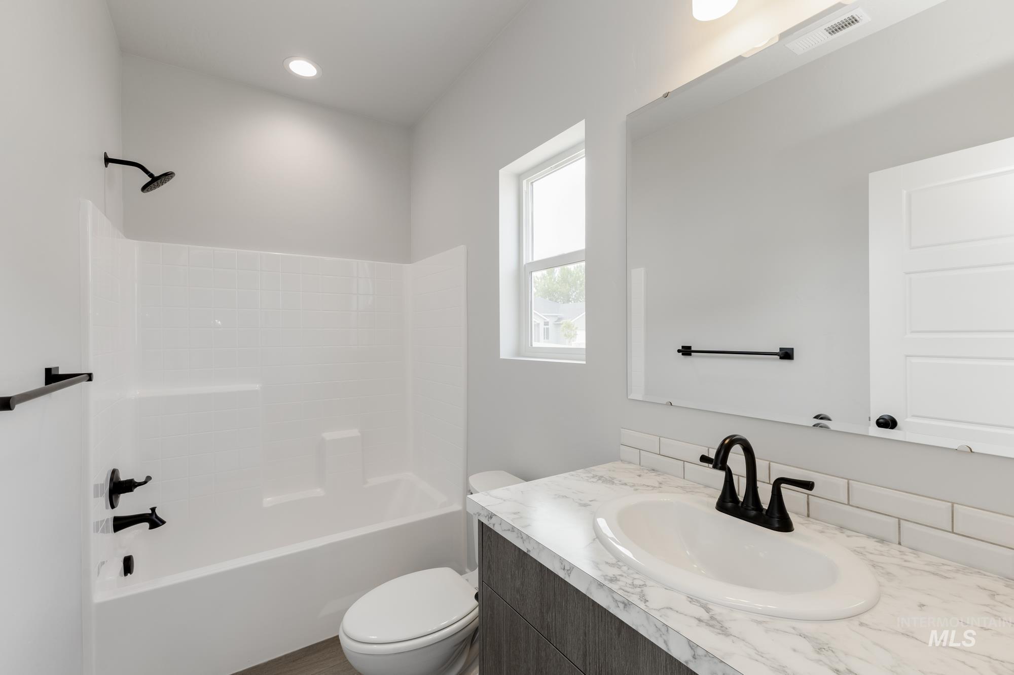 Bathroom featuring bathtub / shower combination and vanity