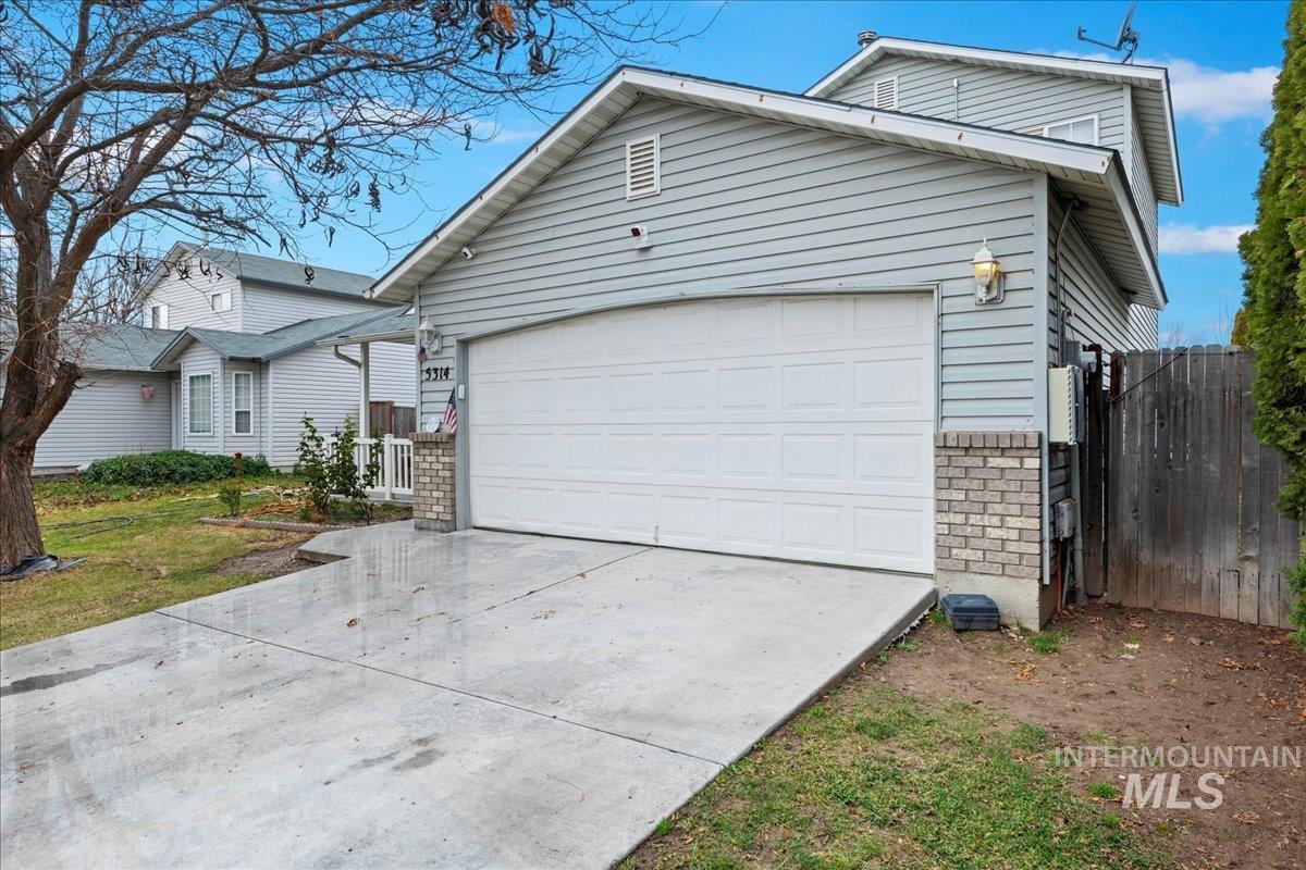 View of front of home with brick siding and driveway