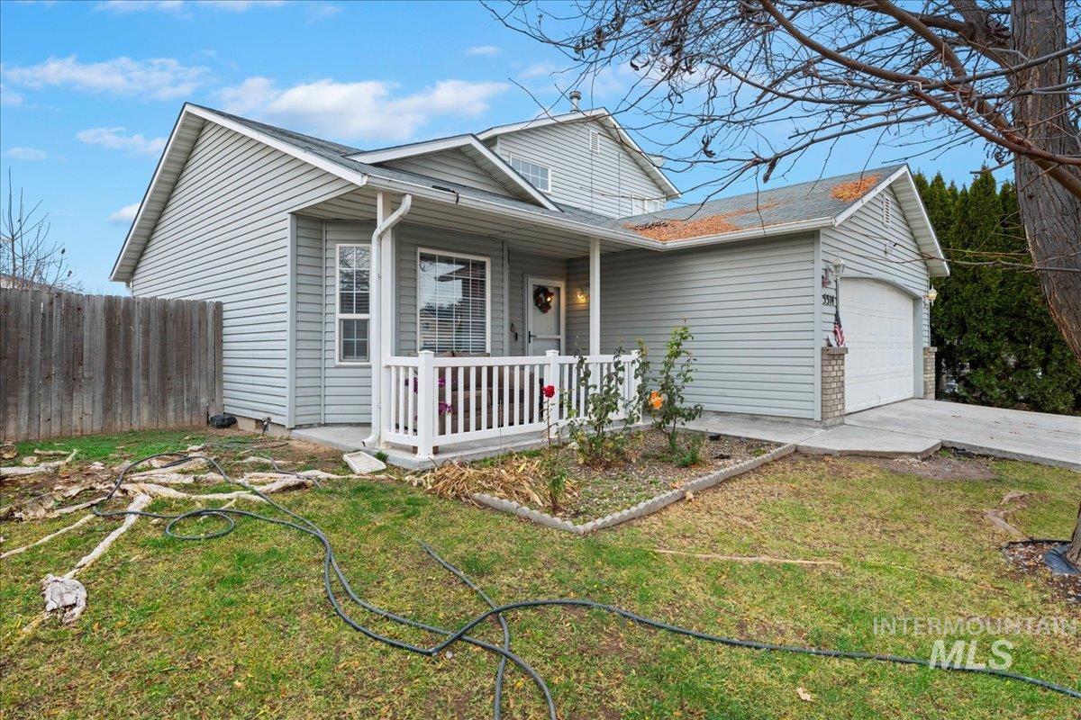 View of front facade with concrete driveway and a garage