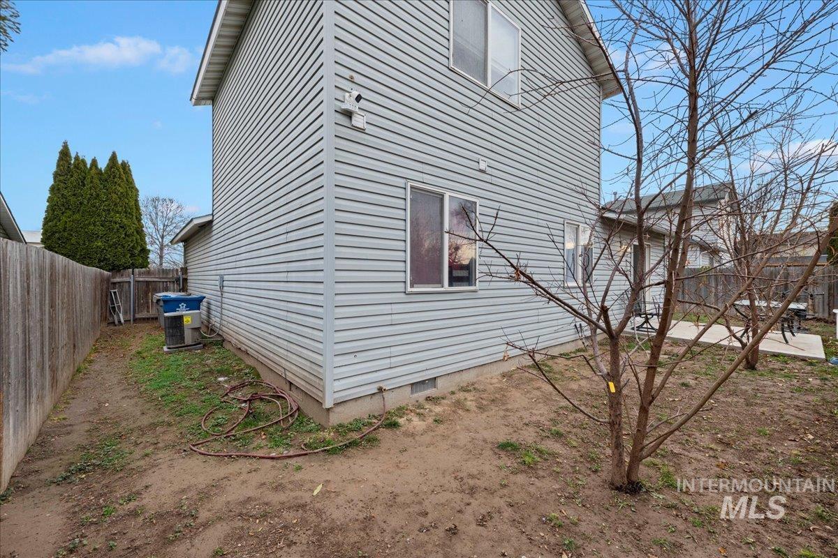View of side of property featuring crawl space and a fenced backyard