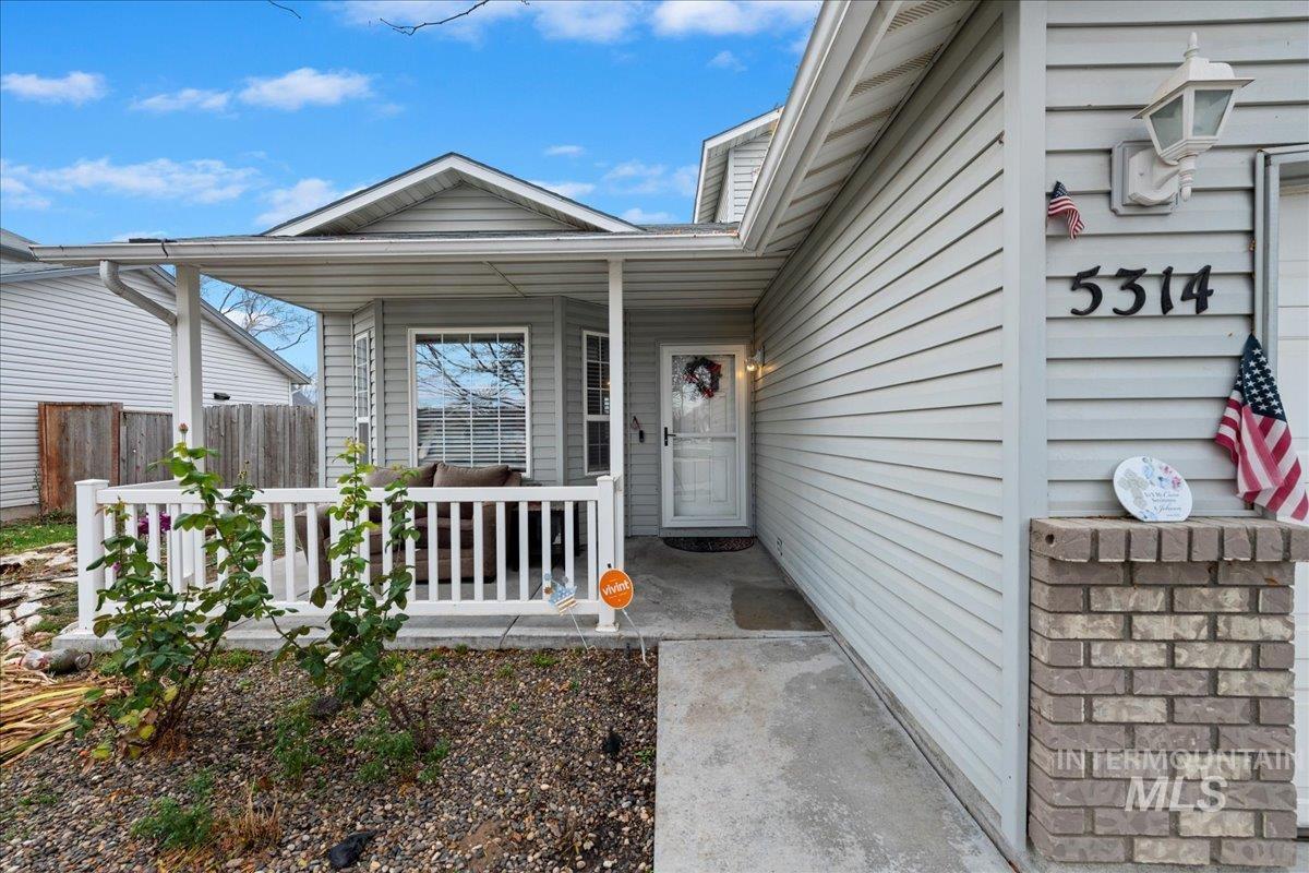 Entrance to property featuring covered porch