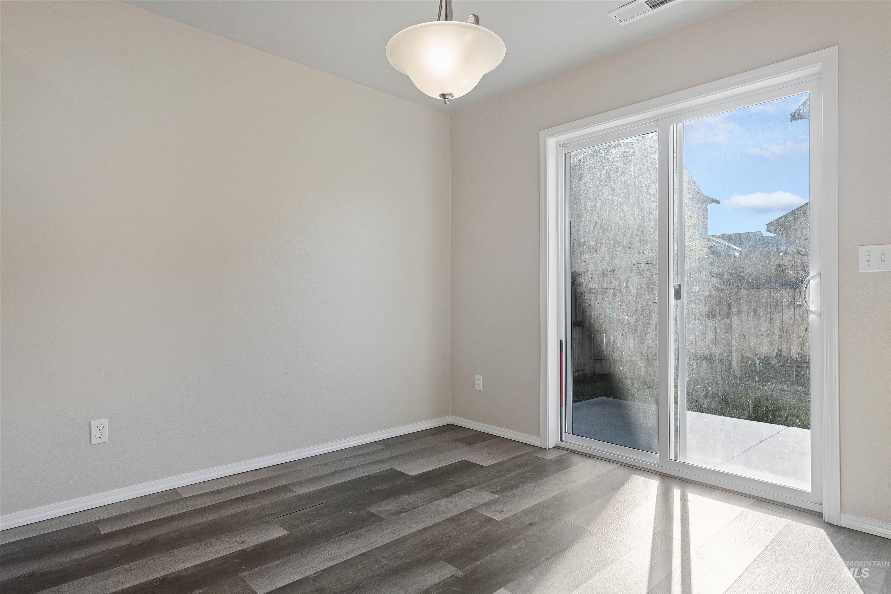 Empty room with light wood-type flooring and baseboards