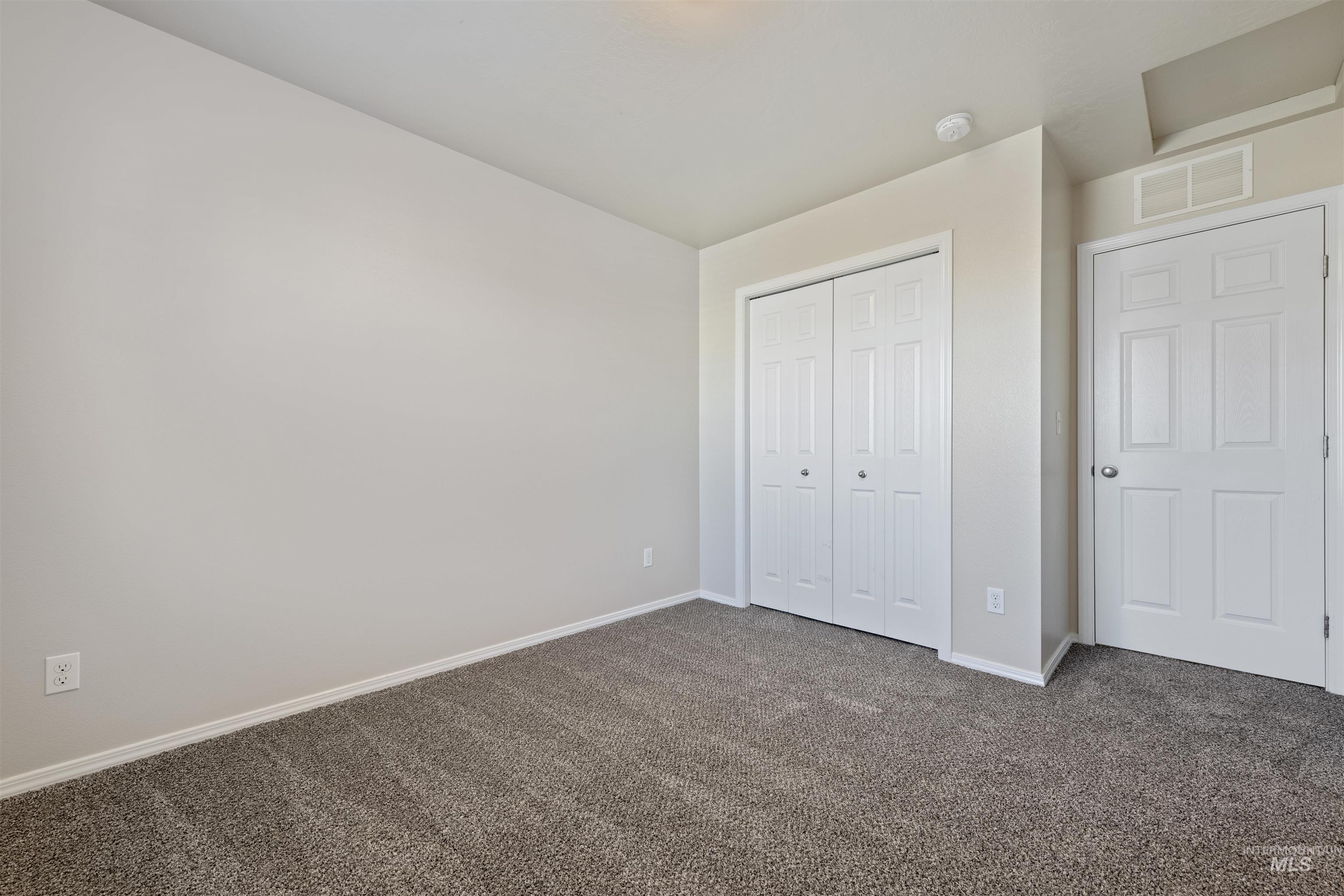 Unfurnished bedroom featuring carpet floors and a closet