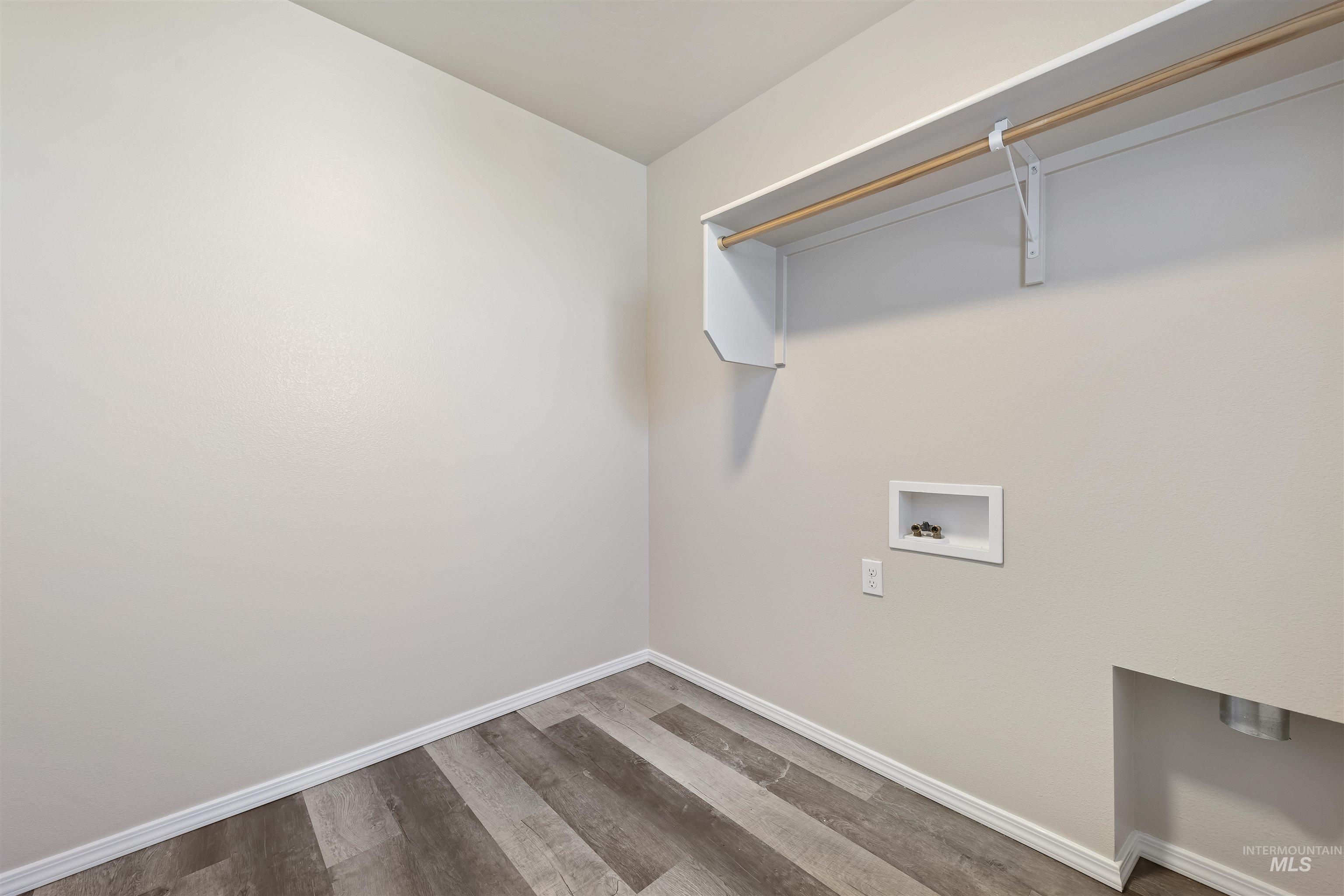 Laundry area featuring wood finished floors and hookup for a washing machine