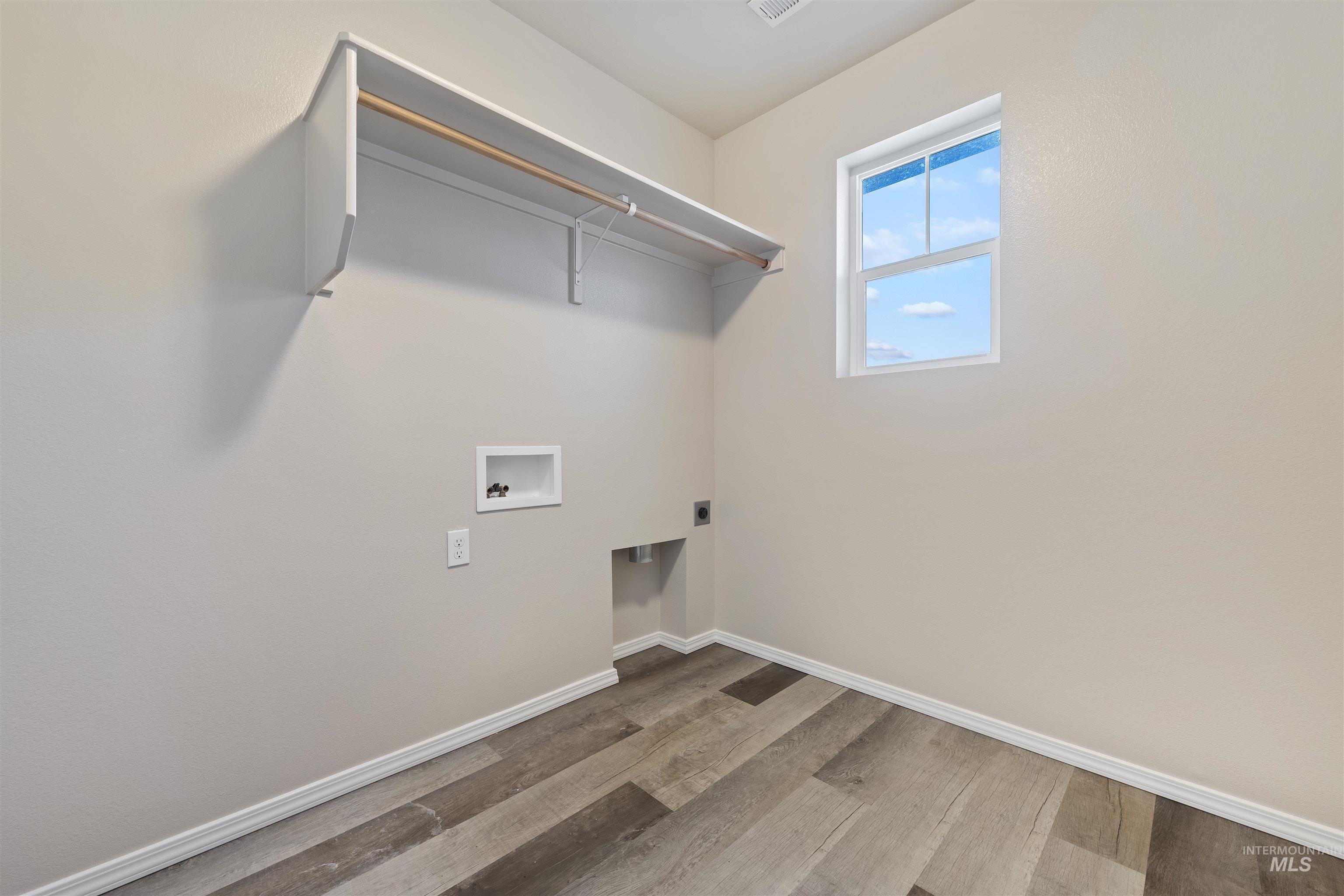 Laundry room featuring light wood-style floors, washer hookup, and hookup for an electric dryer