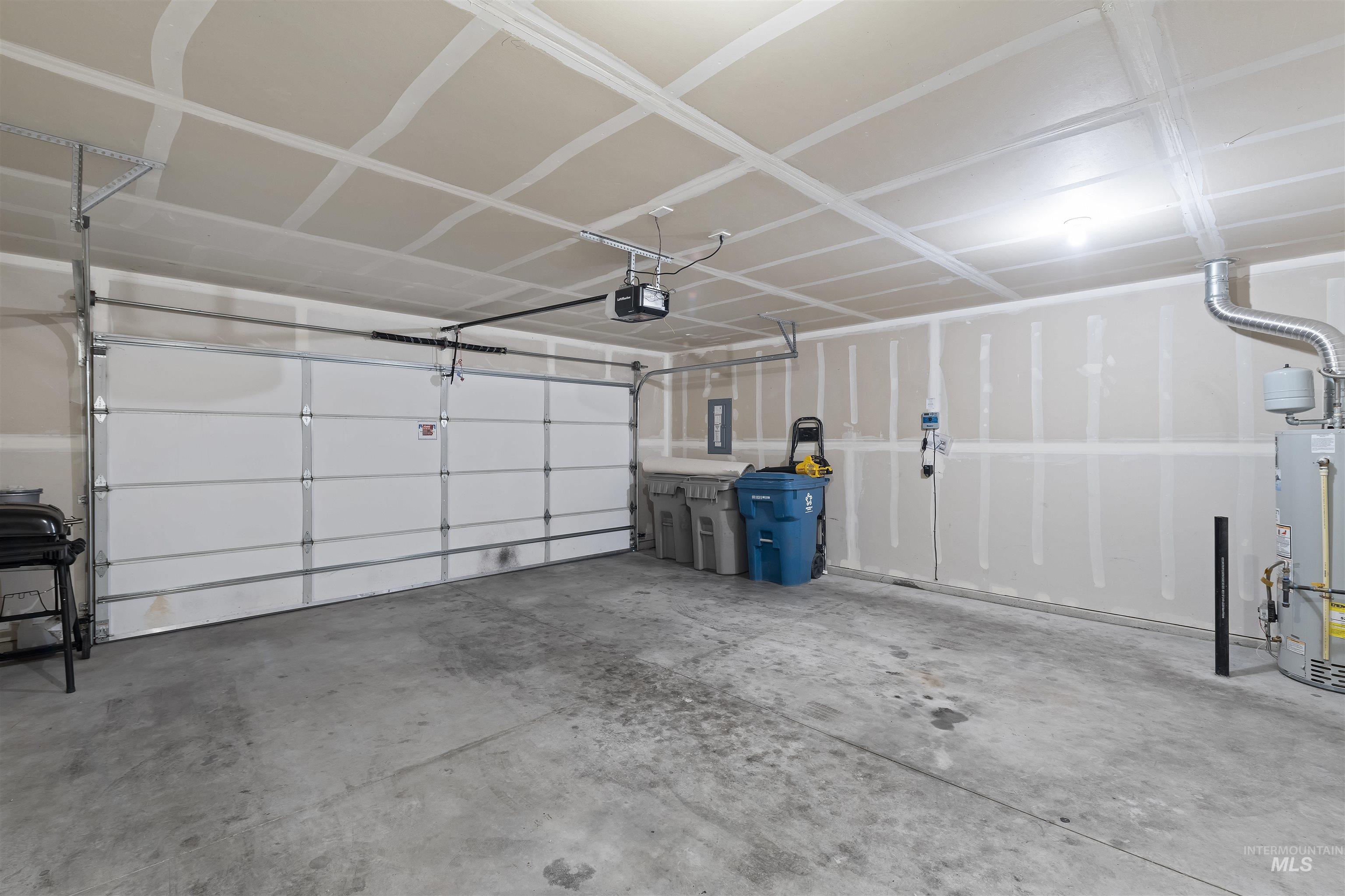 Garage with gas water heater and electric panel