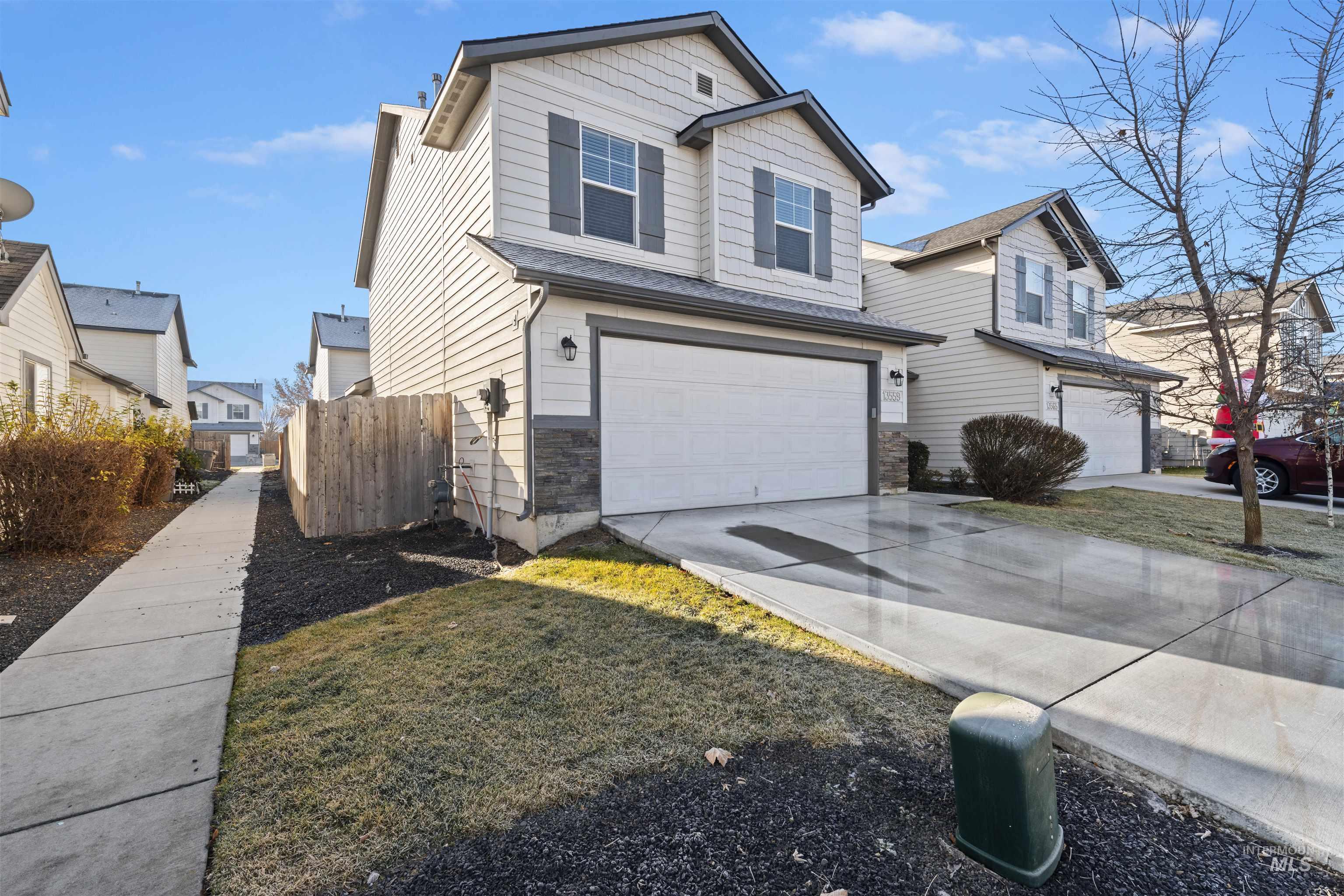 Traditional-style home with concrete driveway and an attached garage