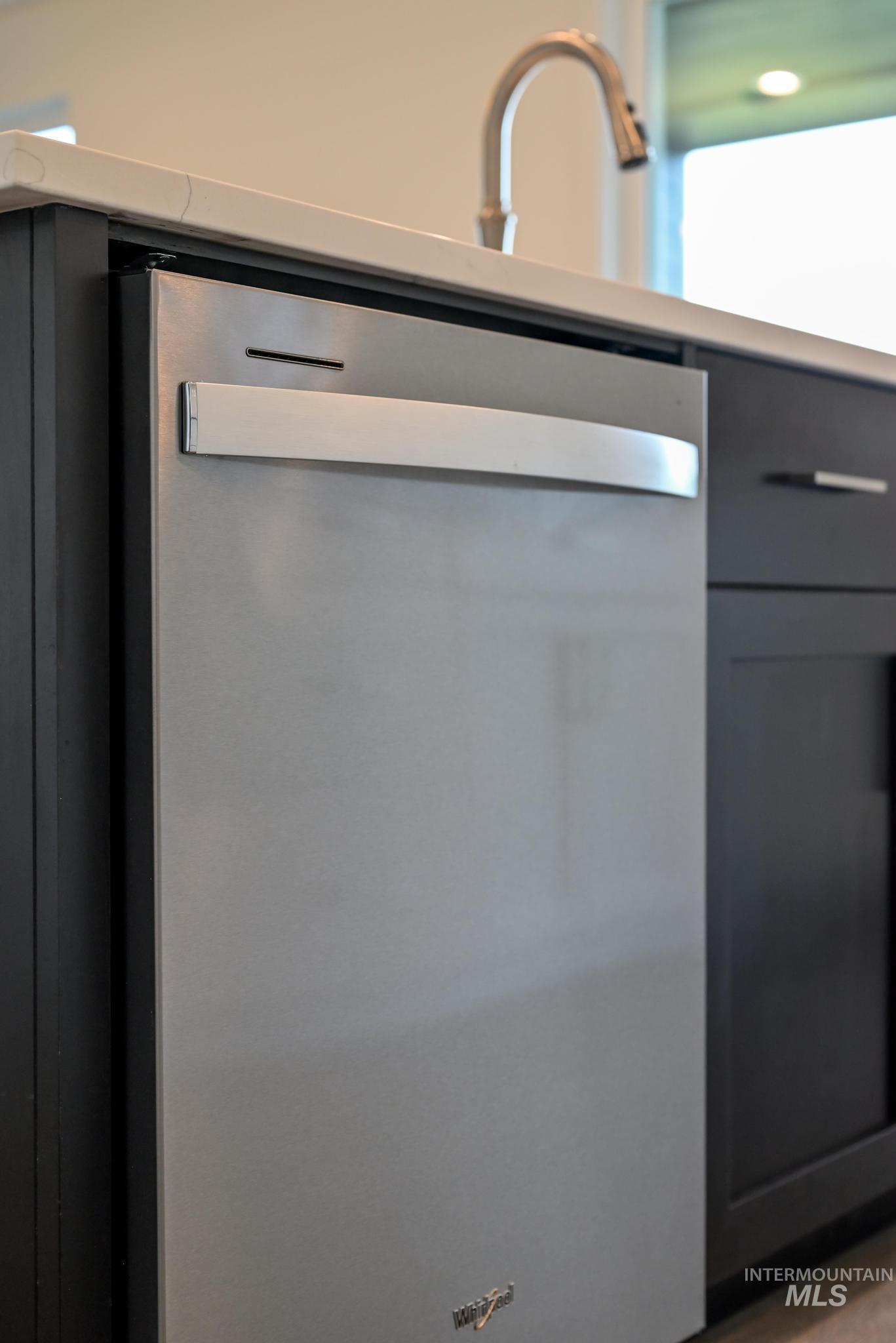 Kitchen view of dishwasher and gray cabinetry