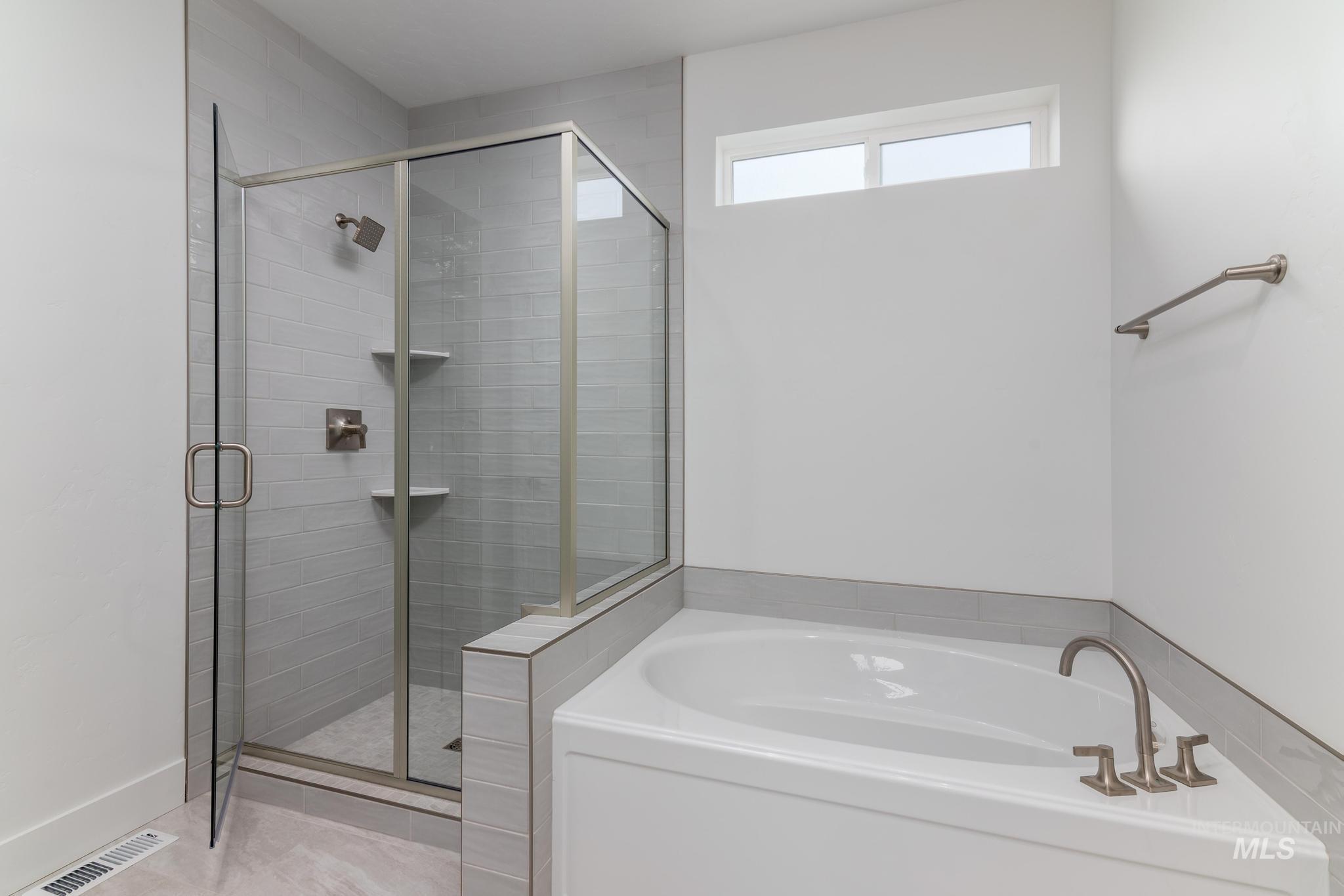 Bathroom with a garden tub and a shower stall