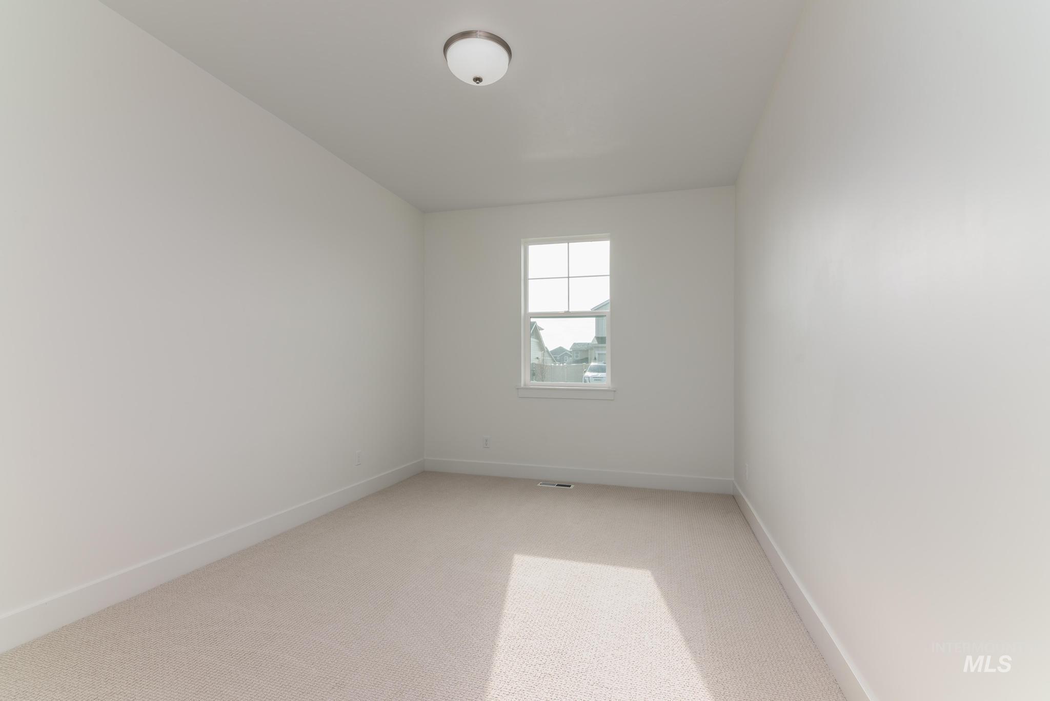 Spare room with carpet flooring and baseboards