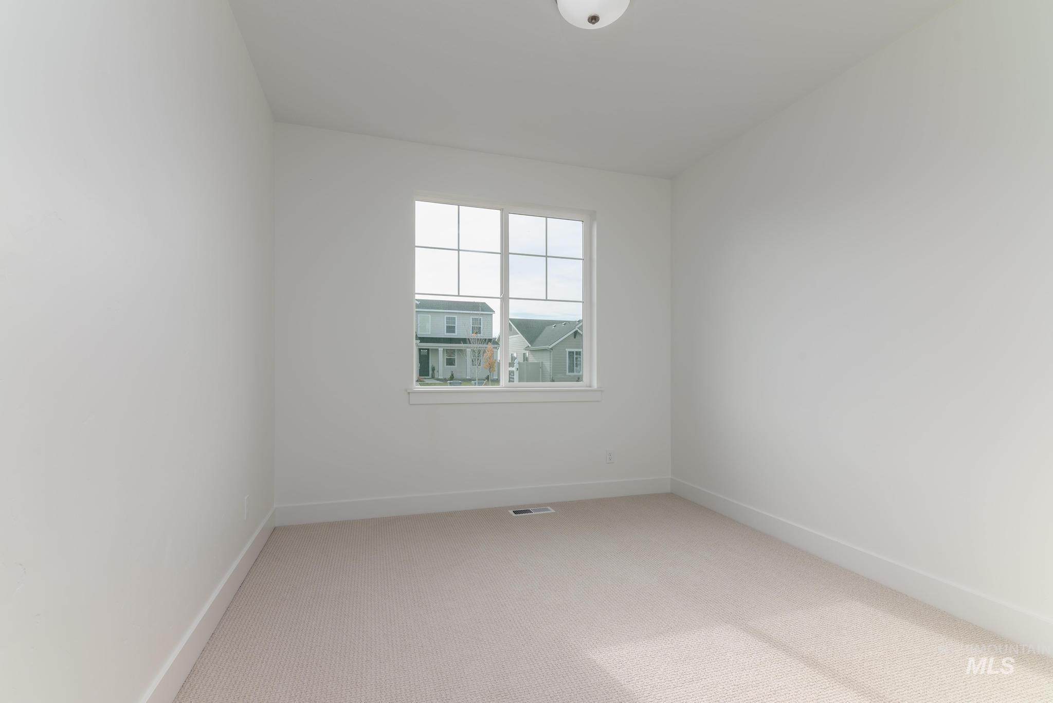 Empty room with carpet floors and baseboards