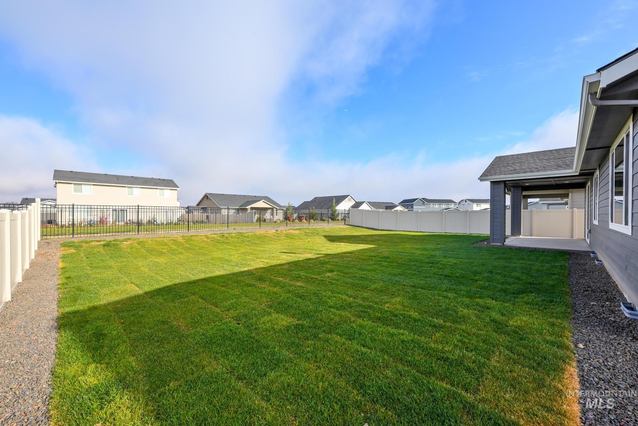 Fenced backyard with a residential view and a patio