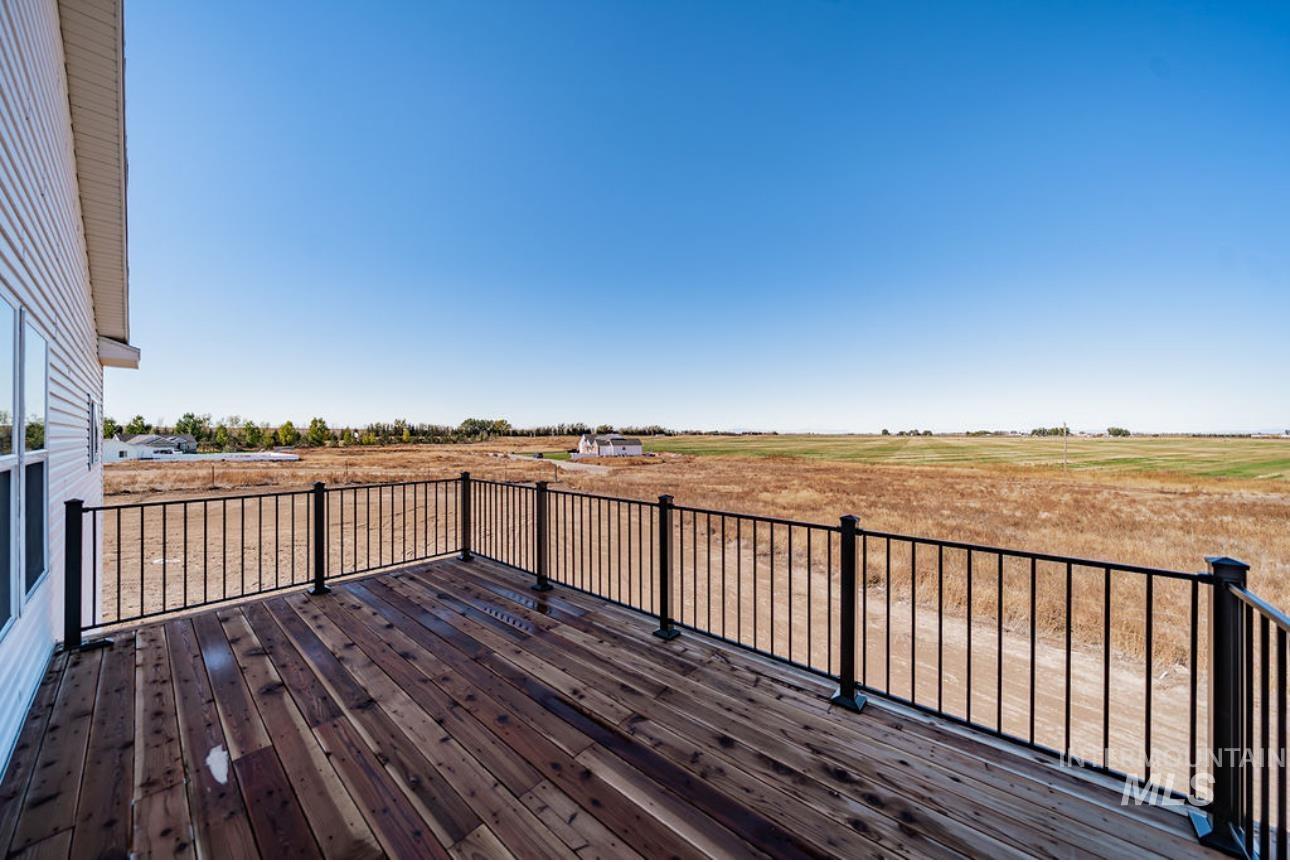 Wooden terrace featuring a view of rural / pastoral area