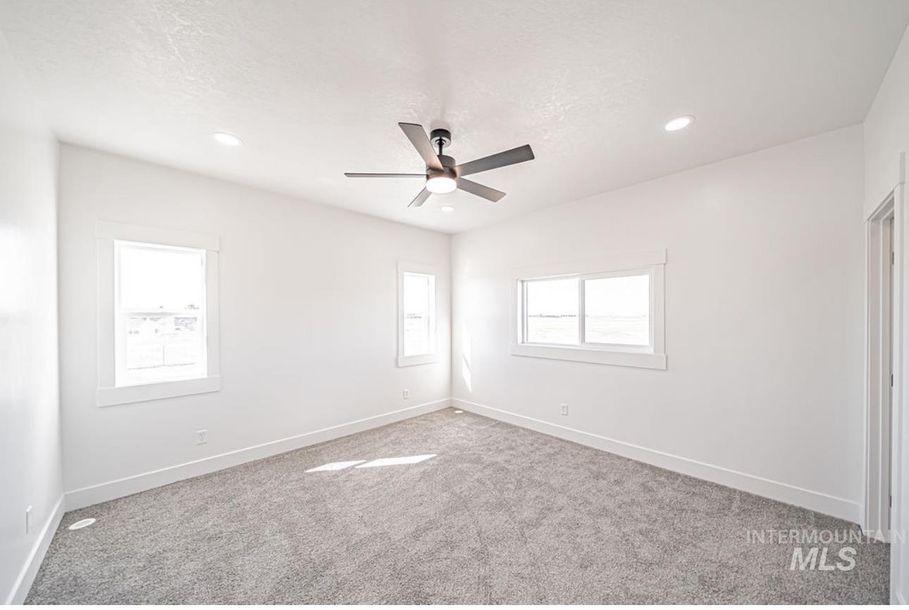 Spare room with light carpet, a ceiling fan, and recessed lighting