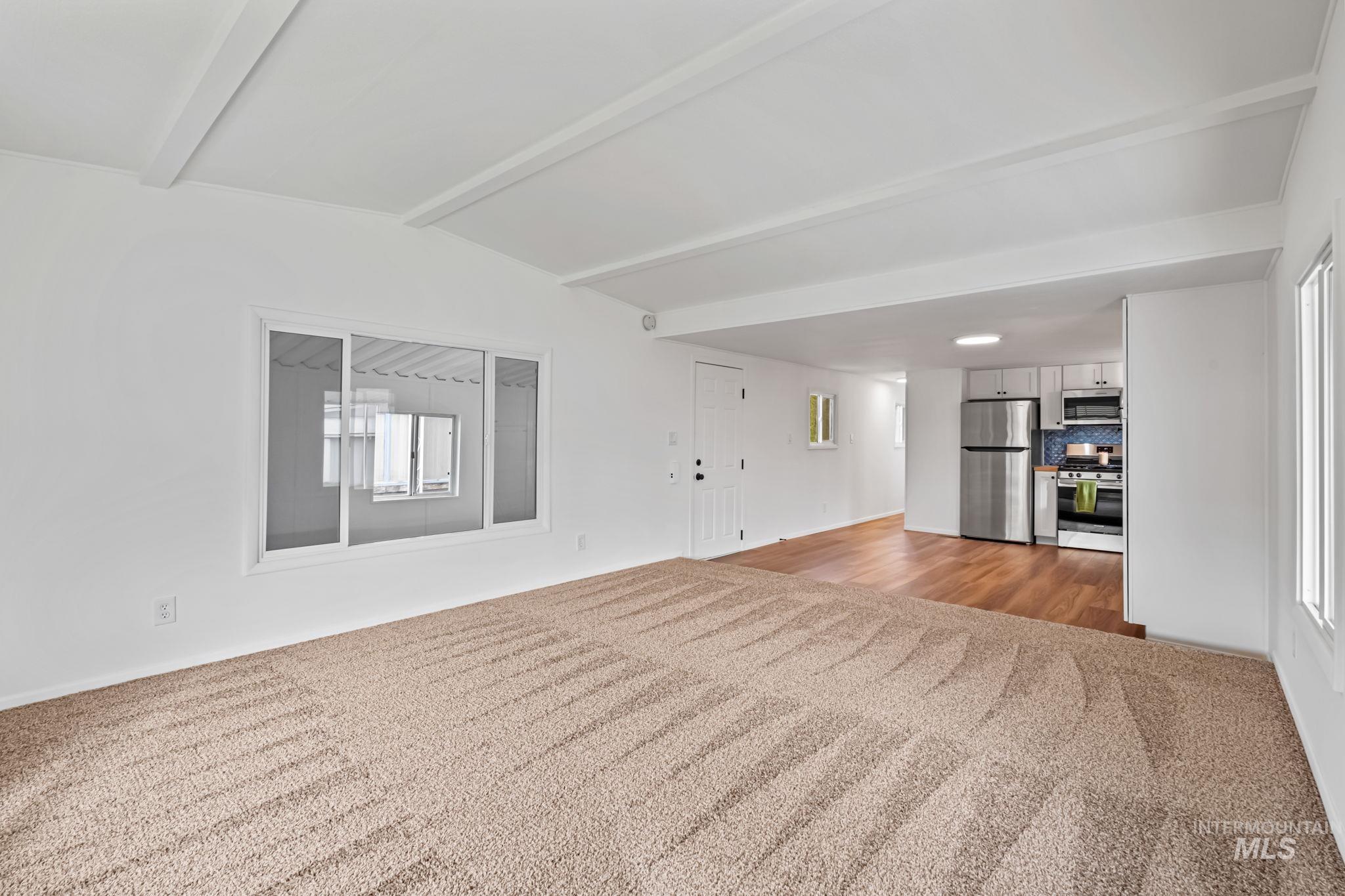 Unfurnished living room with light colored carpet