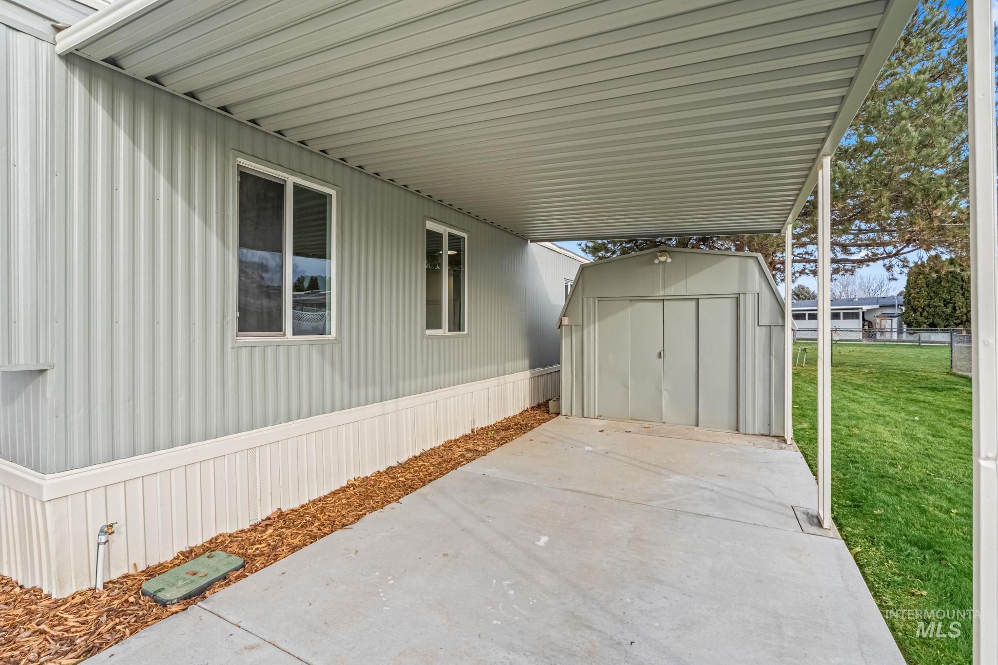 View of patio / terrace with a storage unit and a carport