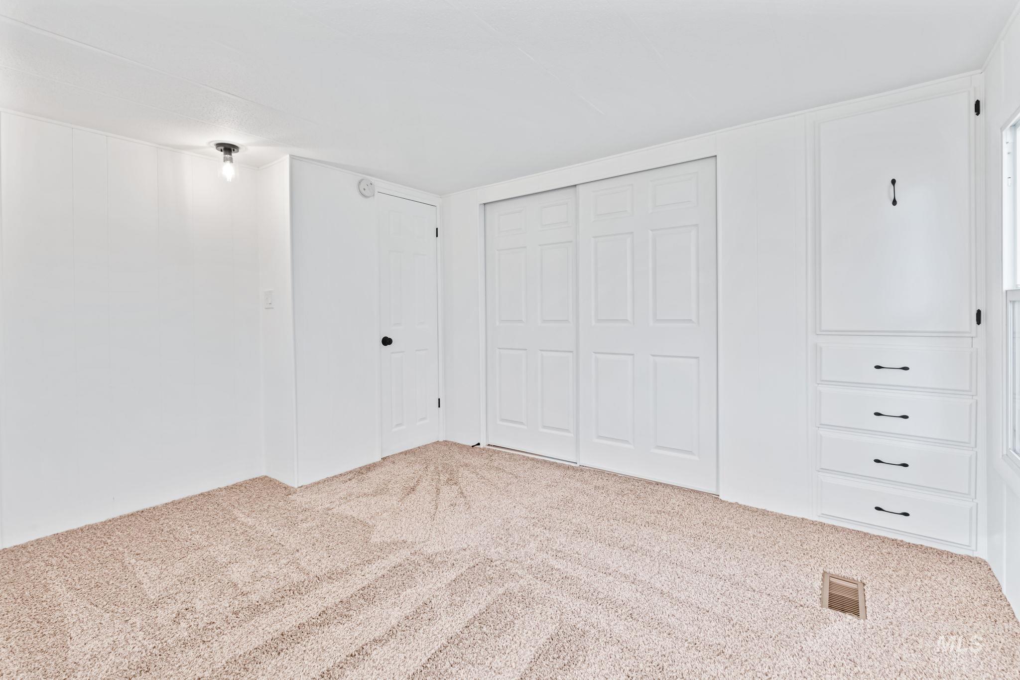 Unfurnished bedroom with a closet and carpet flooring