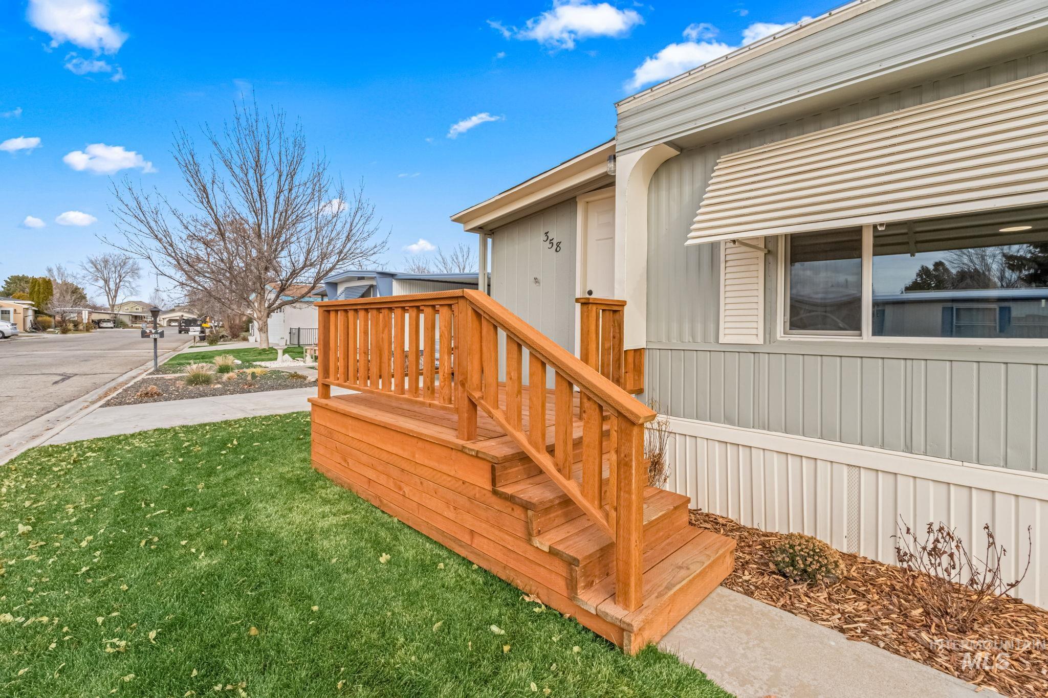 Doorway to property featuring a yard and a residential view