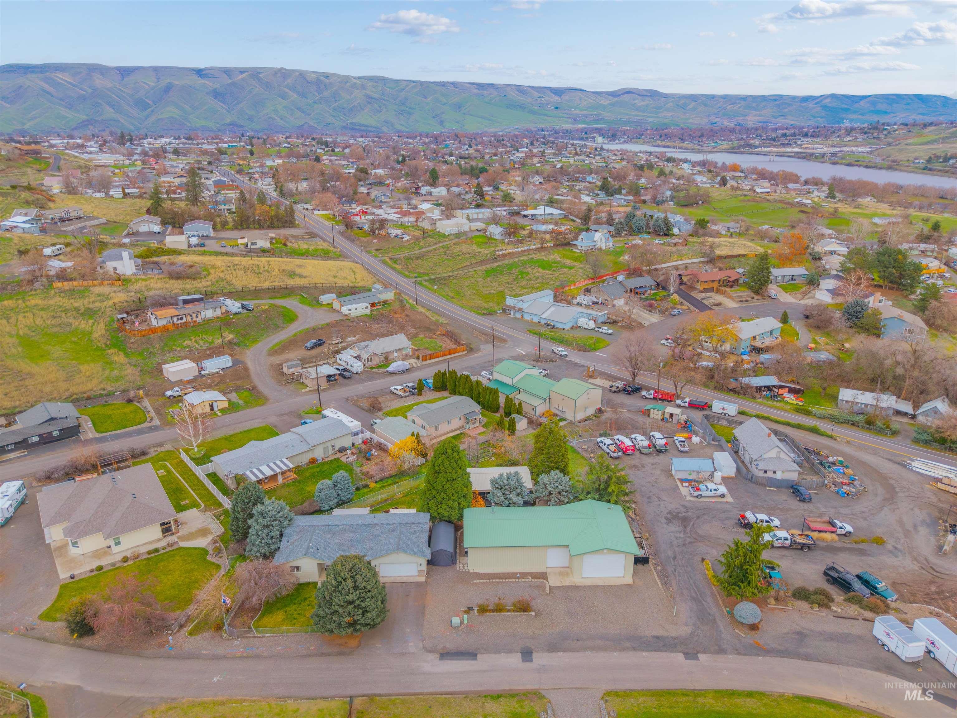 View of property location featuring mountains and nearby suburban area
