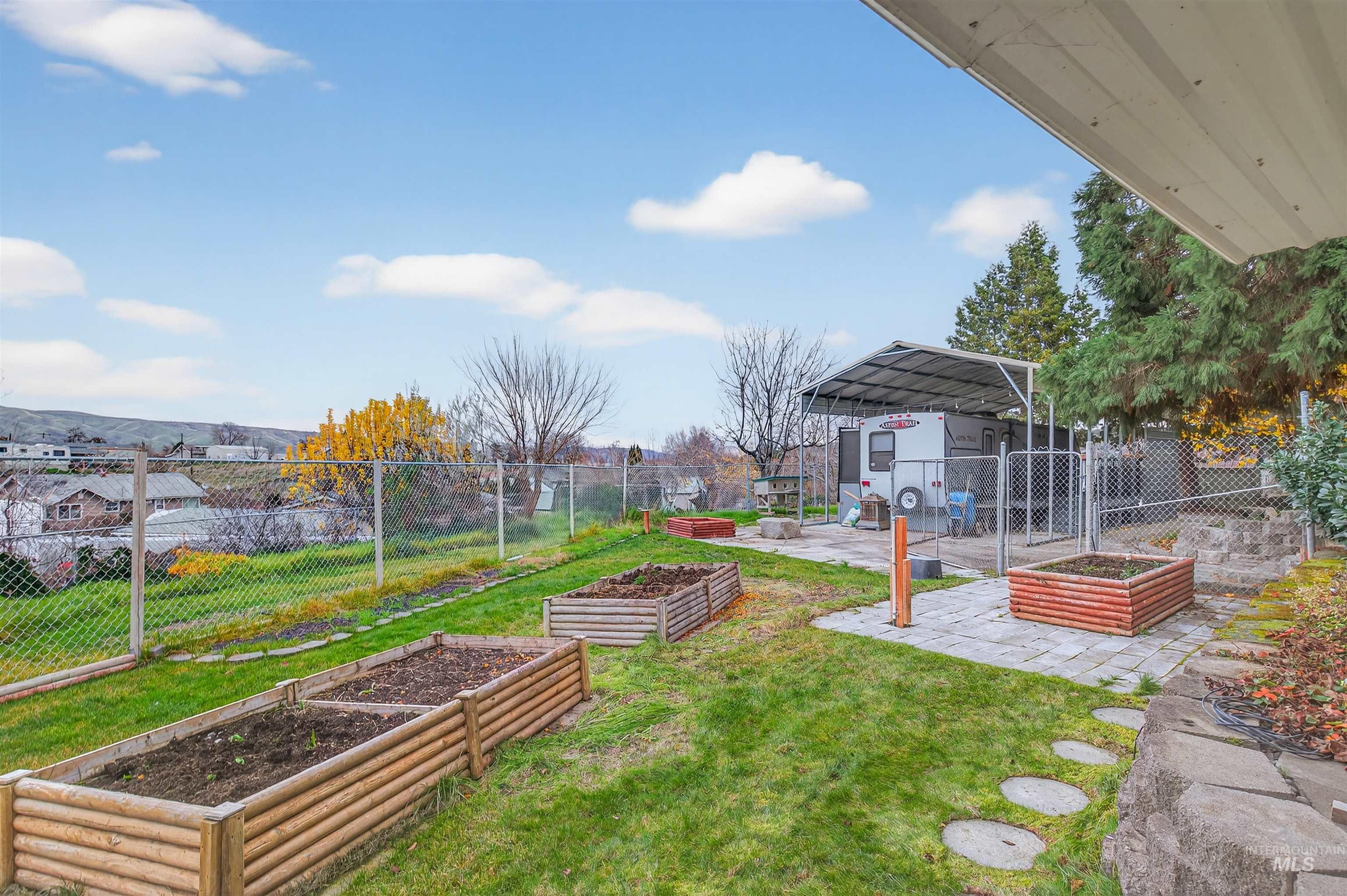 View of yard with a garden and a patio area