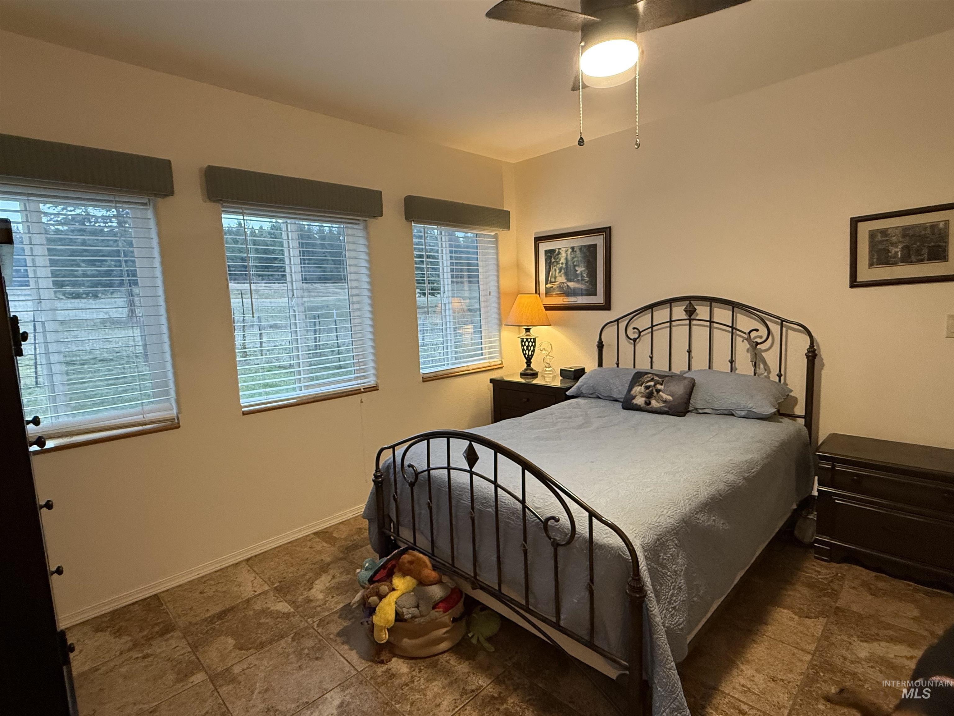 Bedroom featuring baseboards and a ceiling fan