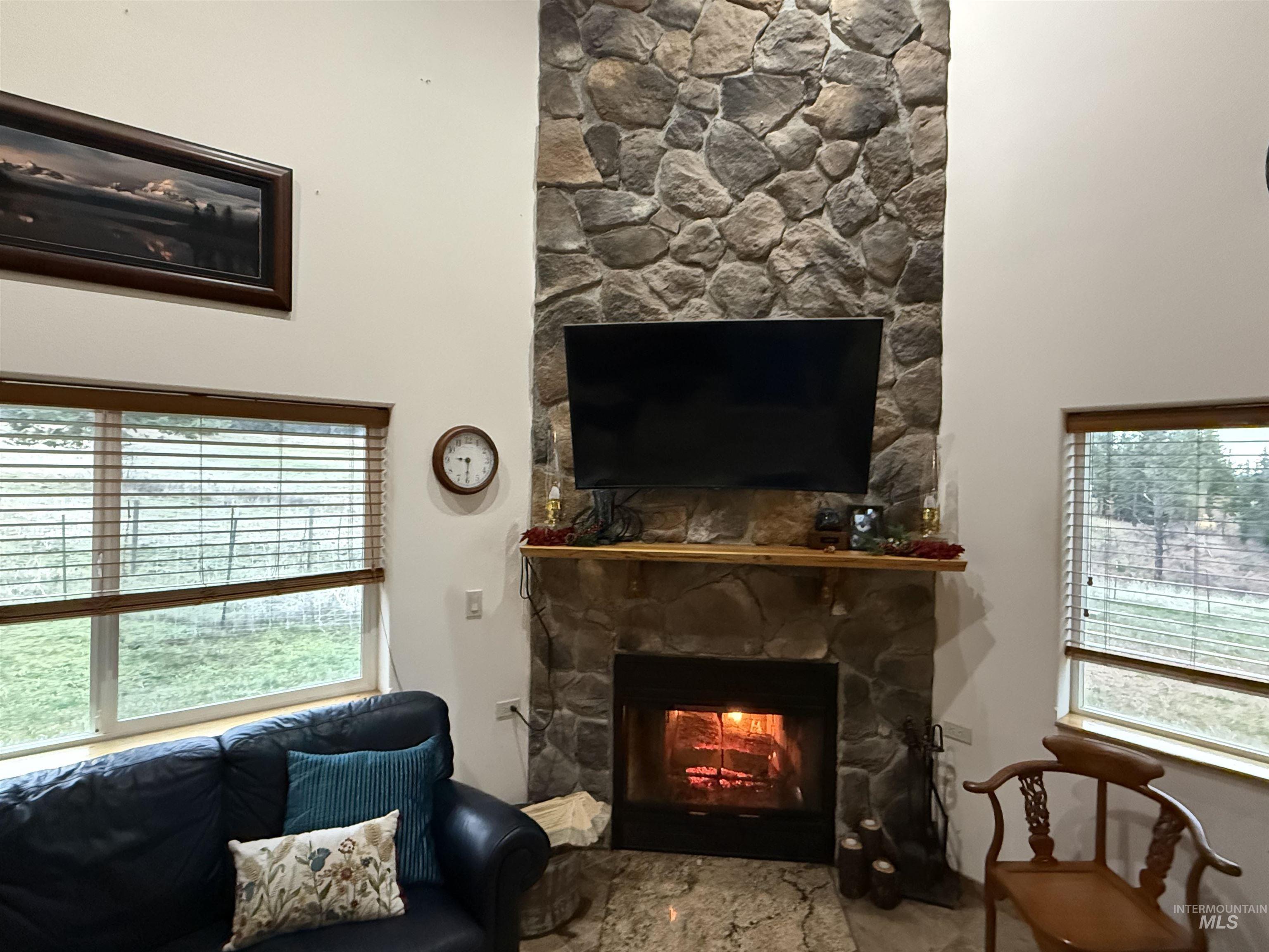 Living room featuring a stone fireplace